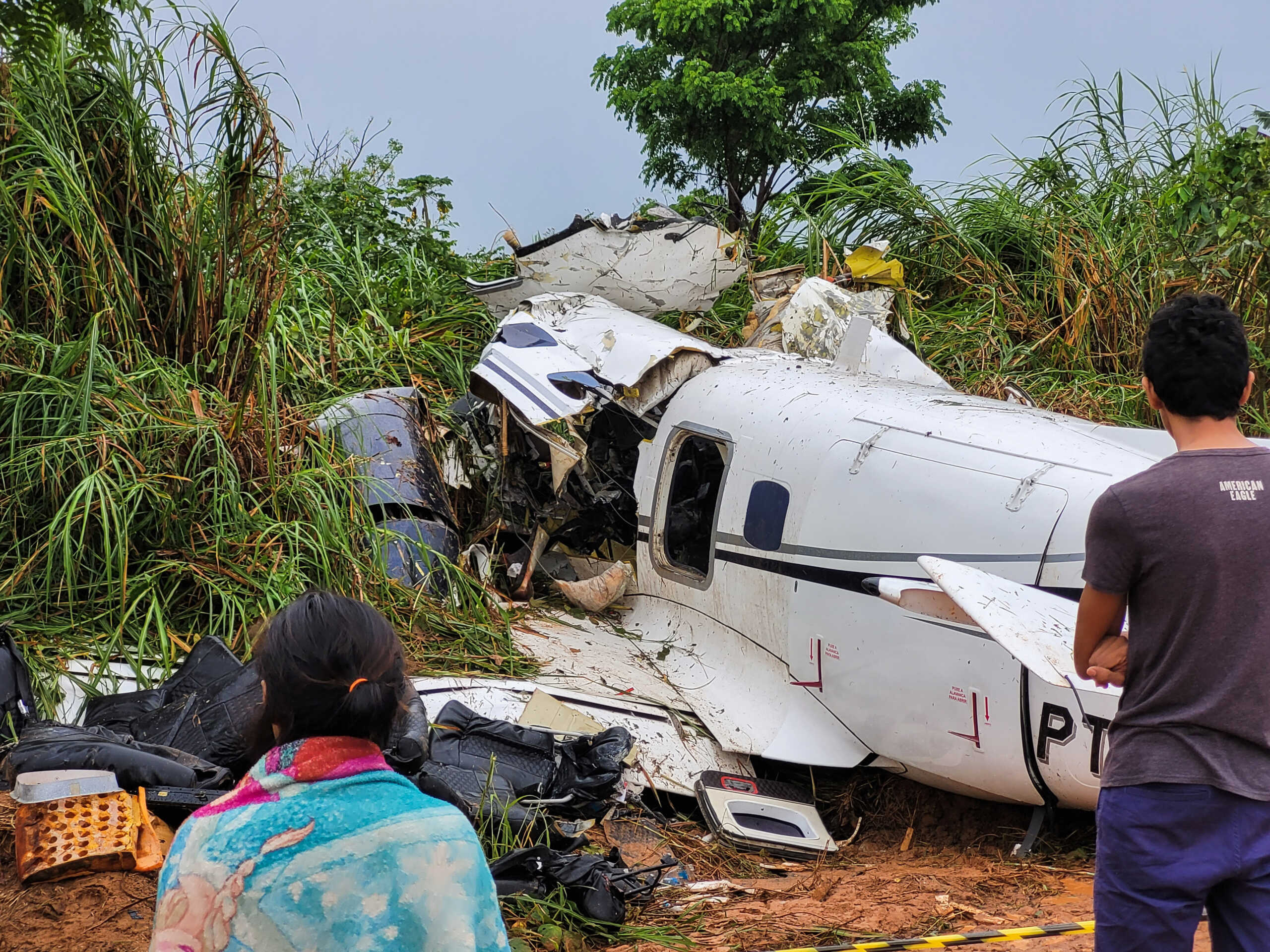 People look at the aircraft after it crashed, which has left 14 dead in Barcelos, Amazonas State Brazil September 16, 2023. REUTERS