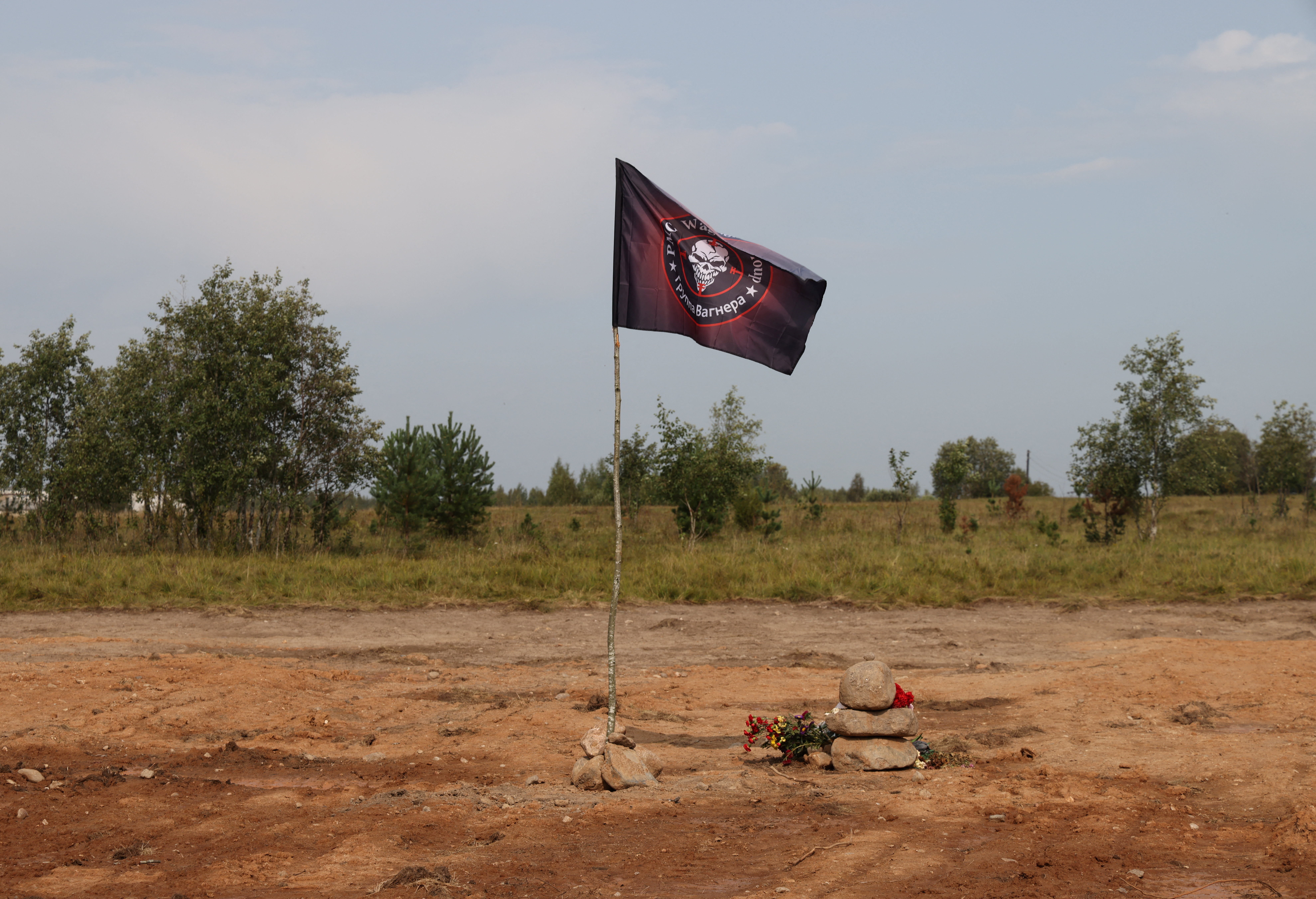 A view shows a flag of the Wagner private mercenary group at the site of the plane crash that killed Wagner PMC top figures, including Yevgeny Prigozhin and Dmitry Utkin, in the Tver Region, Russia September 1, 2023. PICTURE OBTAINED BY REUTERS