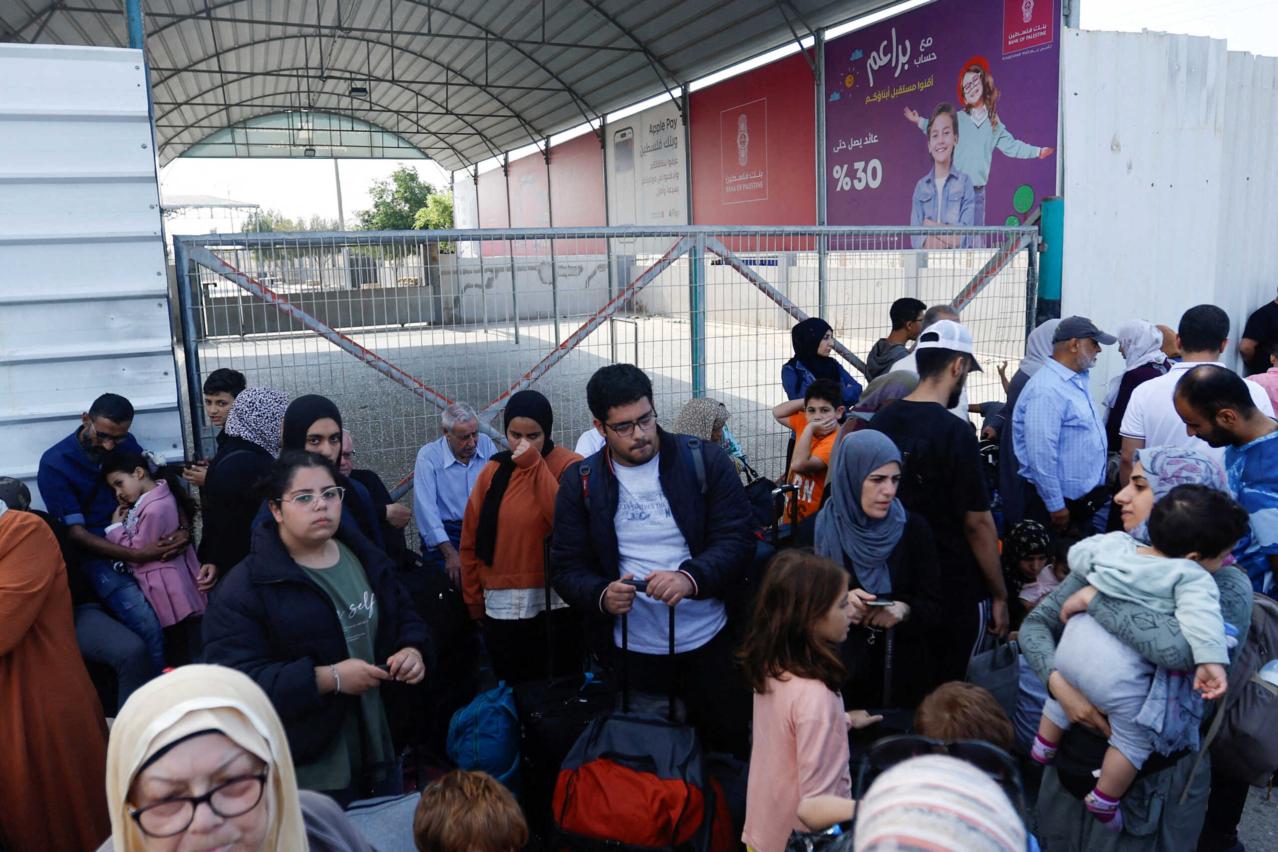 FILE PHOTO: Palestinians with dual citizenship gather outside Rafah border crossing with Egypt in the hope of getting permission to leave Gaza, amid the ongoing Israeli-Palestinian conflict, in Rafah in the southern Gaza Strip October 14, 2023. REUTERS