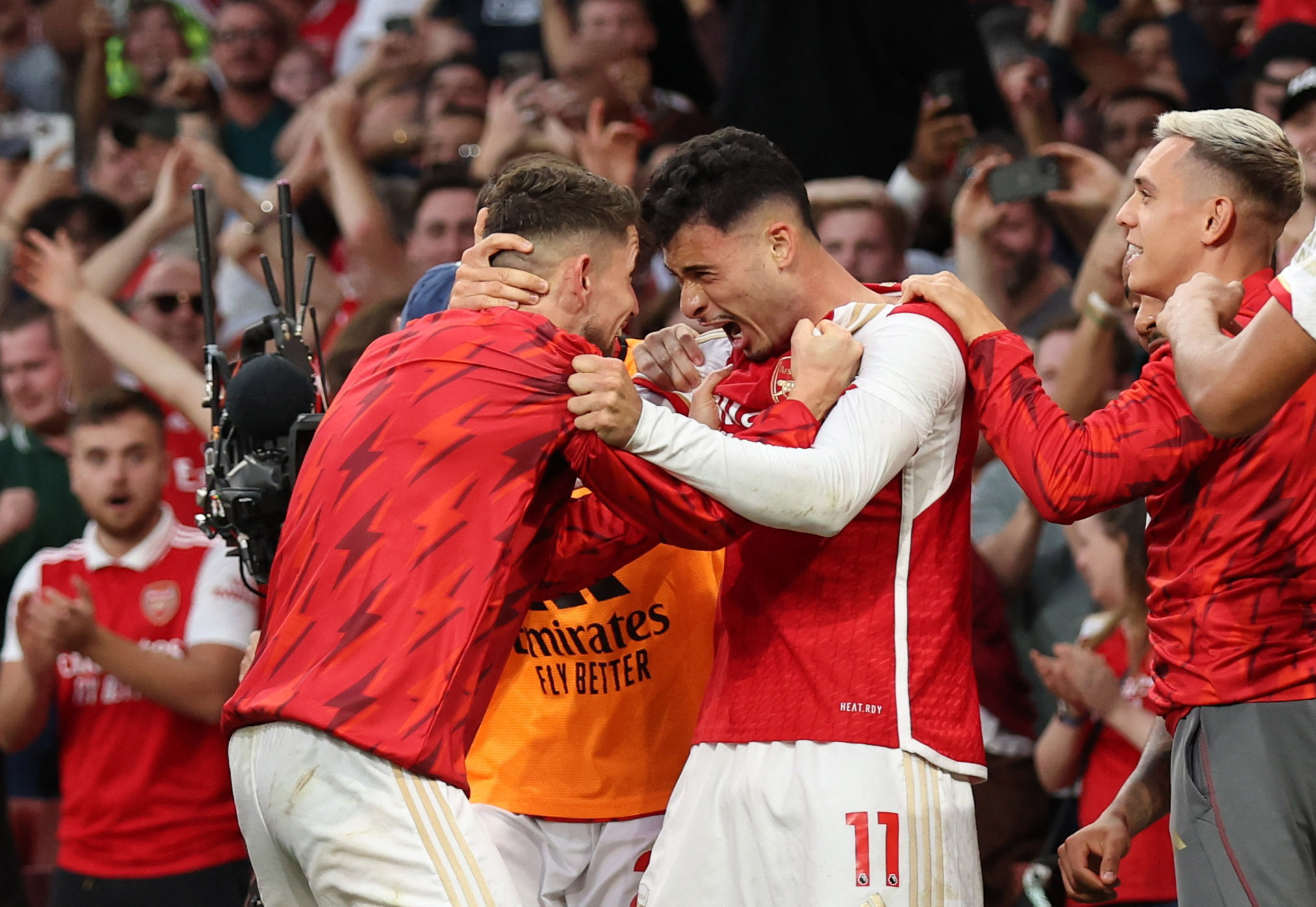 Soccer Football - Premier League - Arsenal v Manchester City - Emirates Stadium, London, Britain - October 8, 2023 Arsenal's Gabriel Martinelli celebrates scoring their first goal with Jorginho REUTERS