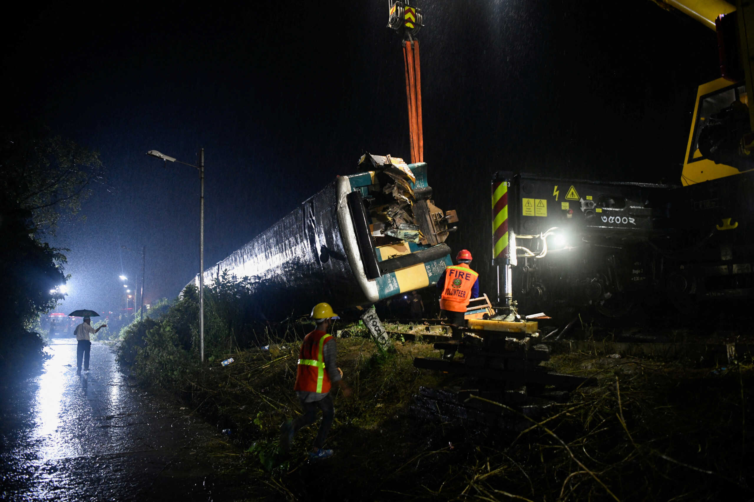 Rescue workers from the Fire Service and Civil Defence work to move the derailed compartments in order to restore the rail communication after two trains collided in Bhairab, about 80 kilometres northeast of the capital Dhaka, Bangladesh, October 23, 2023. REUTERS