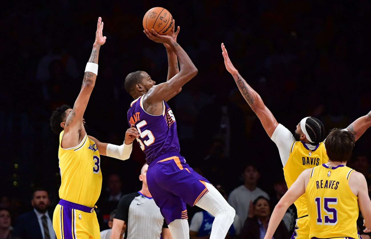 Oct 26, 2023; Los Angeles, California, USA; Phoenix Suns forward Kevin Durant (35) shoots against Los Angeles Lakers forward Anthony Davis (3) forward Christian Wood (35) and guard Austin Reaves (15) during the second half at Crypto.com Arena. Mandatory Credit: Gary A. Vasquez-USA TODAY Sports
