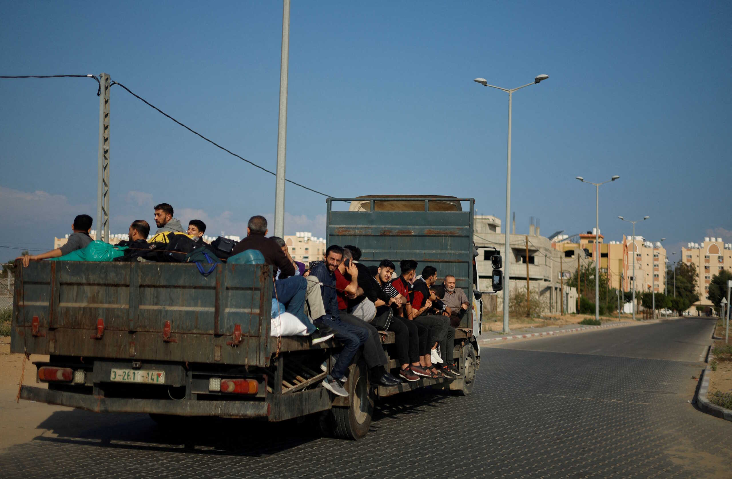 FILE PHOTO: Palestinians flee their houses amid Israeli strikes after Israel's call for more than 1 million civilians in northern Gaza to move south, in Khan Younis in the southern Gaza Strip, October 14, 2023.  REUTERS