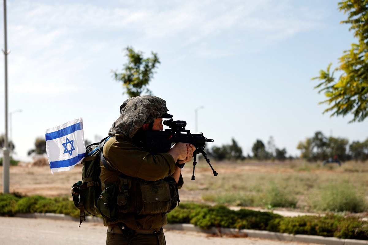 An Israeli soldier secures an area, following a deadly infiltration by Hamas gunmen from the Gaza Strip, in Kibbutz Kissufim in southern Israel October 21, 2023. REUTERS