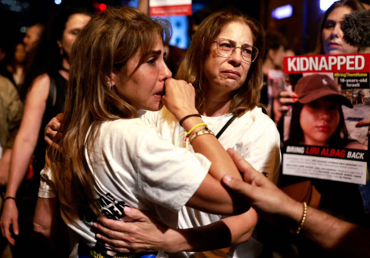 People react as residents of Tel Aviv show support and solidarity with the families of hostages who are being held in Gaza, amid the ongoing conflict between Israel and Hamas, in Tel Aviv, Israel, October 21, 2023. REUTERS