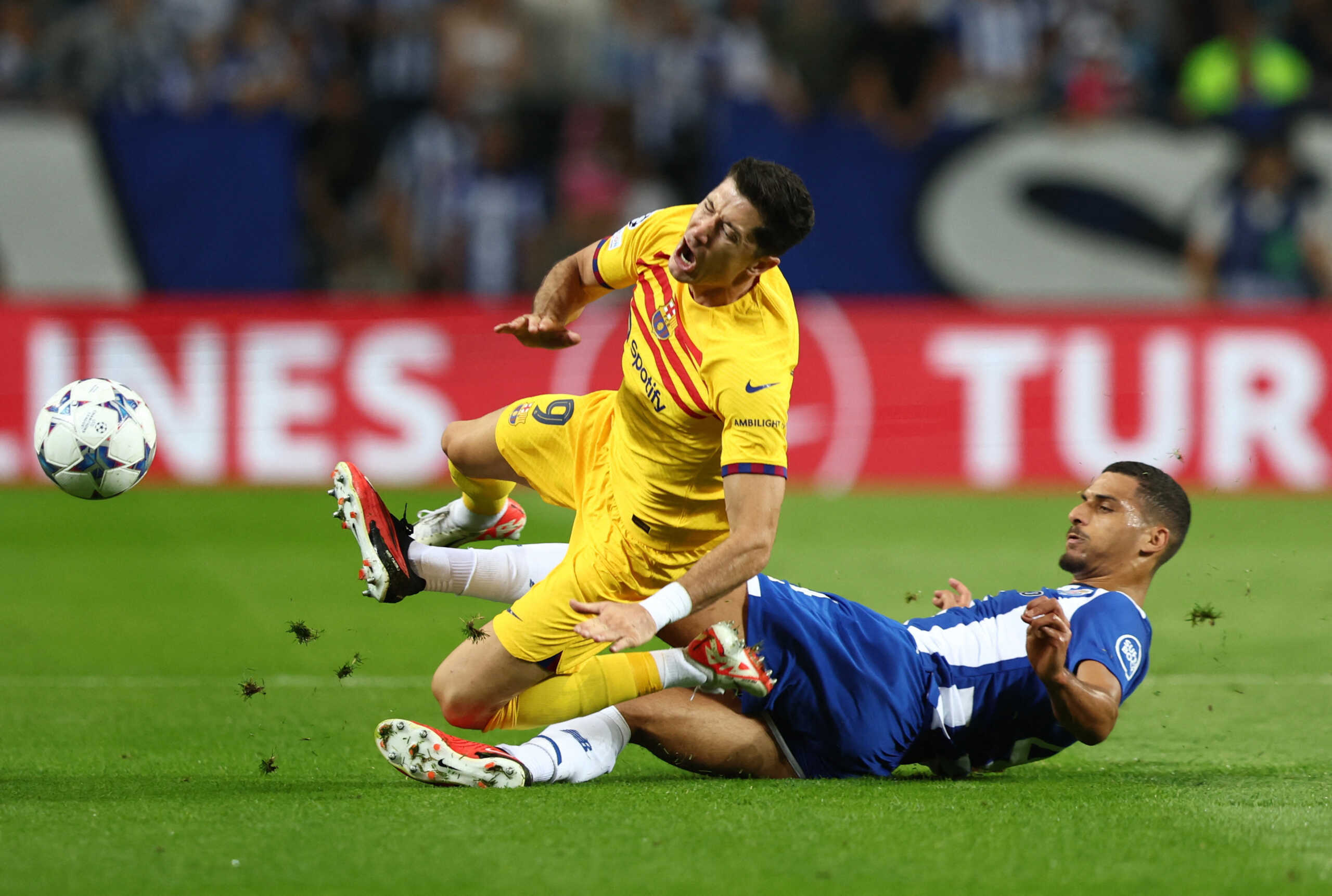 Soccer Football - Champions League - Group H - FC Porto v FC Barcelona - Estadio do Dragao, Porto, Portugal - October 4, 2023 FC Barcelona's Robert Lewandowski is fouled by FC Porto's David Carmo REUTERS