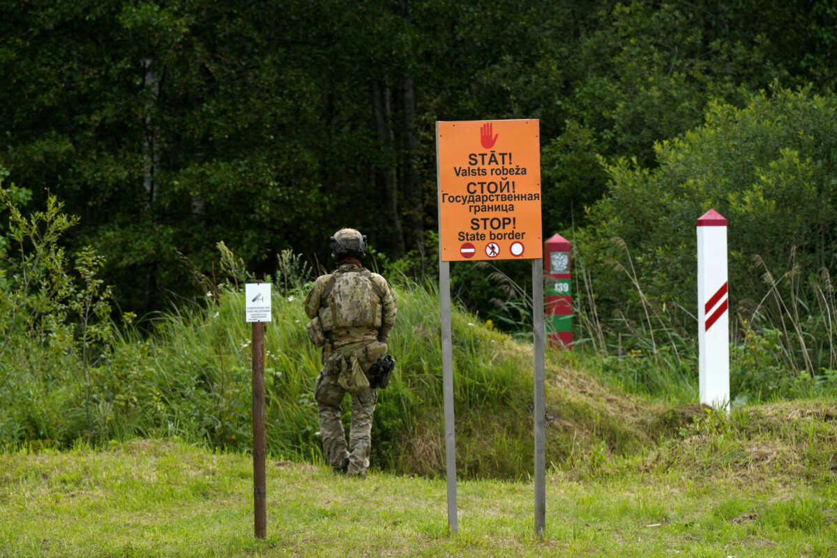 FILE PHOTO: Latvian and Russian border signs are seen at the Latvia-Russia border near Lidumnieki, Latvia August 8, 2023. REUTERS