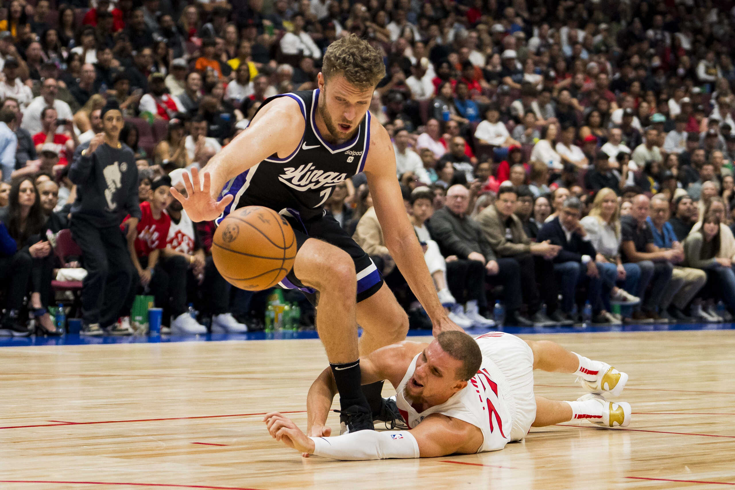 Oct 8, 2023; Vancouver, British Columbia, CAN; Toronto Raptors guard Malachi Flynn (22) and Sacramento Kings forward Sasha Vezenkov (7) battle for the loose ball in the second half at Rogers Arena. Raptors won 112-99. Mandatory Credit: Bob Frid-USA TODAY Sports