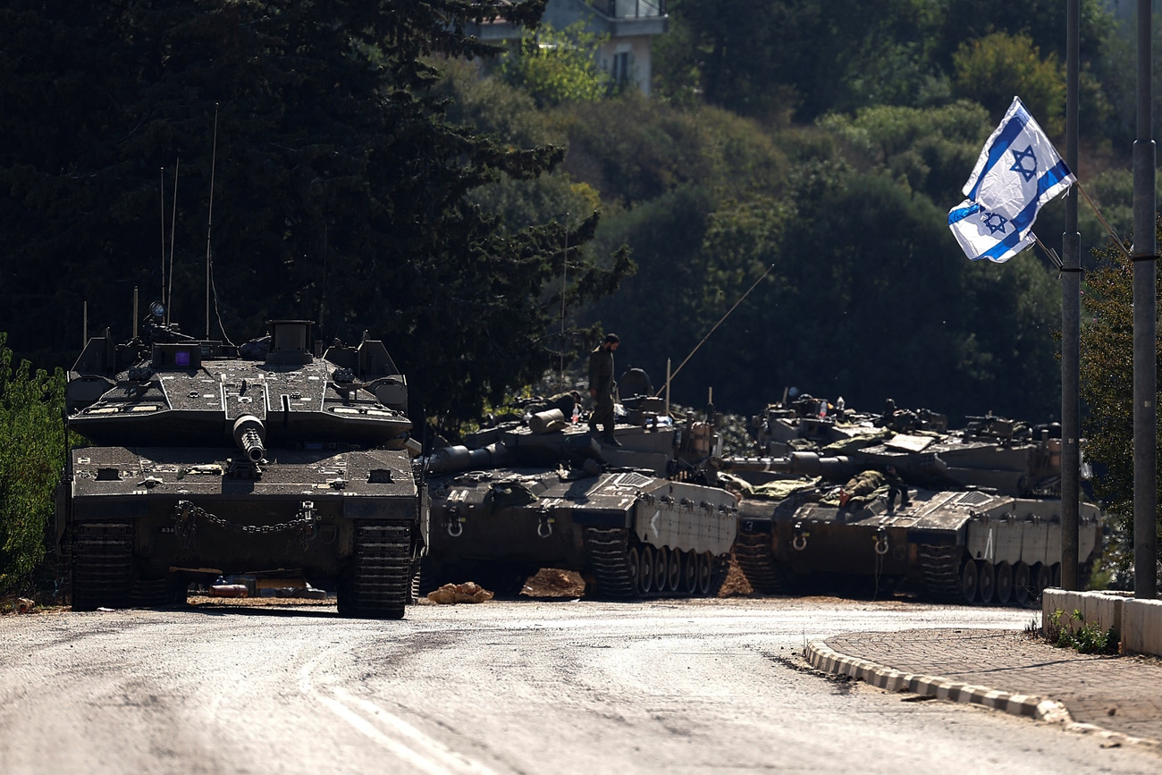 Israeli tanks are seen on a road near Israel's border with Lebanon, in northern Israel, October 12, 2023. REUTERS