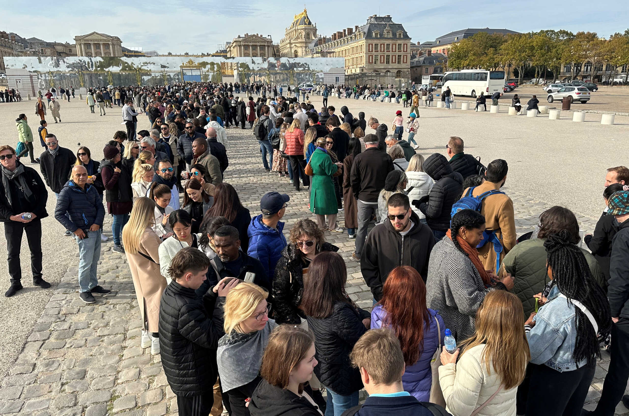 Tourists queue to enter the Chateau de Versailles (Versailles Palace) after it was evacuated for security reasons, in Versailles, near Paris, France, October 17, 2023. REUTERS