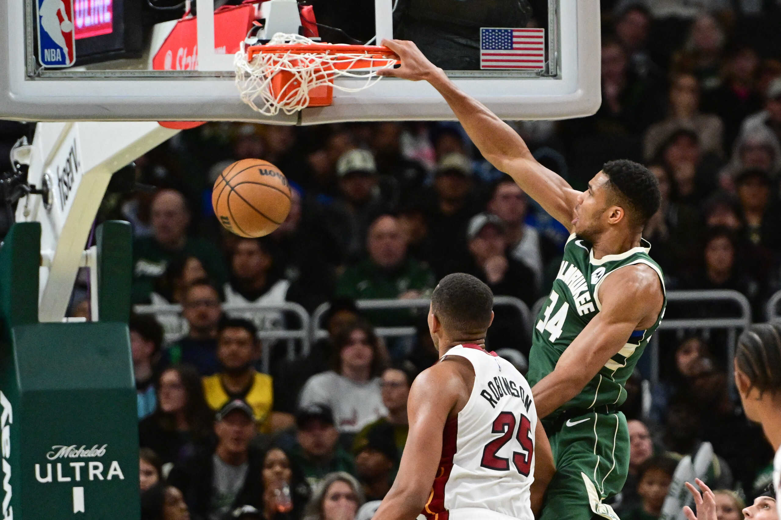 Oct 30, 2023; Milwaukee, Wisconsin, USA; Milwaukee Bucks forward Giannis Antetokounmpo (34) dunks a basket against Miami Heat center Orlando Robinson (25) in the fourth quarter at Fiserv Forum. Mandatory Credit: Benny Sieu-USA TODAY Sports