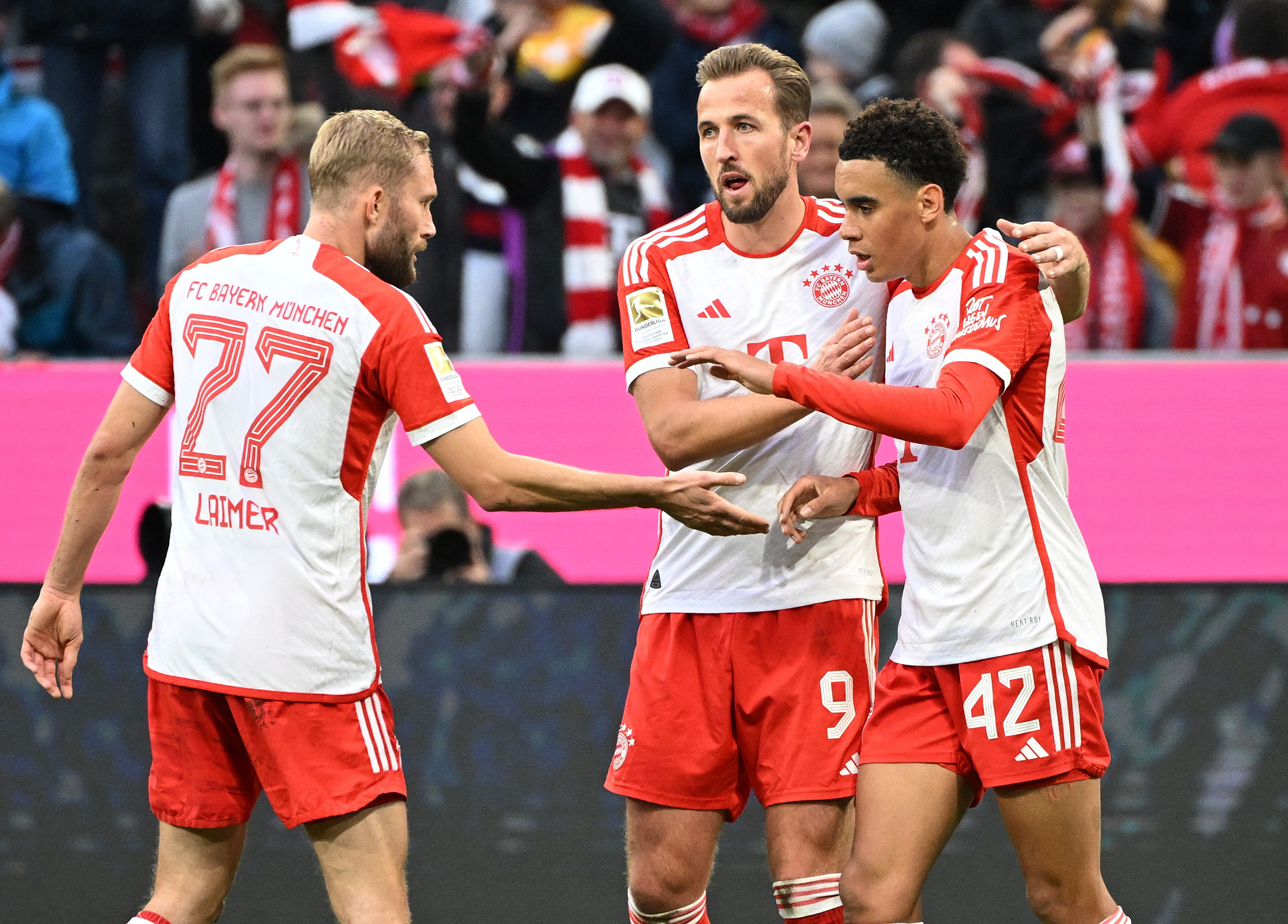 Soccer Football - Bundesliga - Bayern Munich v SV Darmstadt 98 - Allianz Arena, Munich, Germany - October 28, 2023  Bayern Munich's Jamal Musiala celebrates scoring their seventh goal with teammates Konrad Laimer and Harry Kane REUTERS