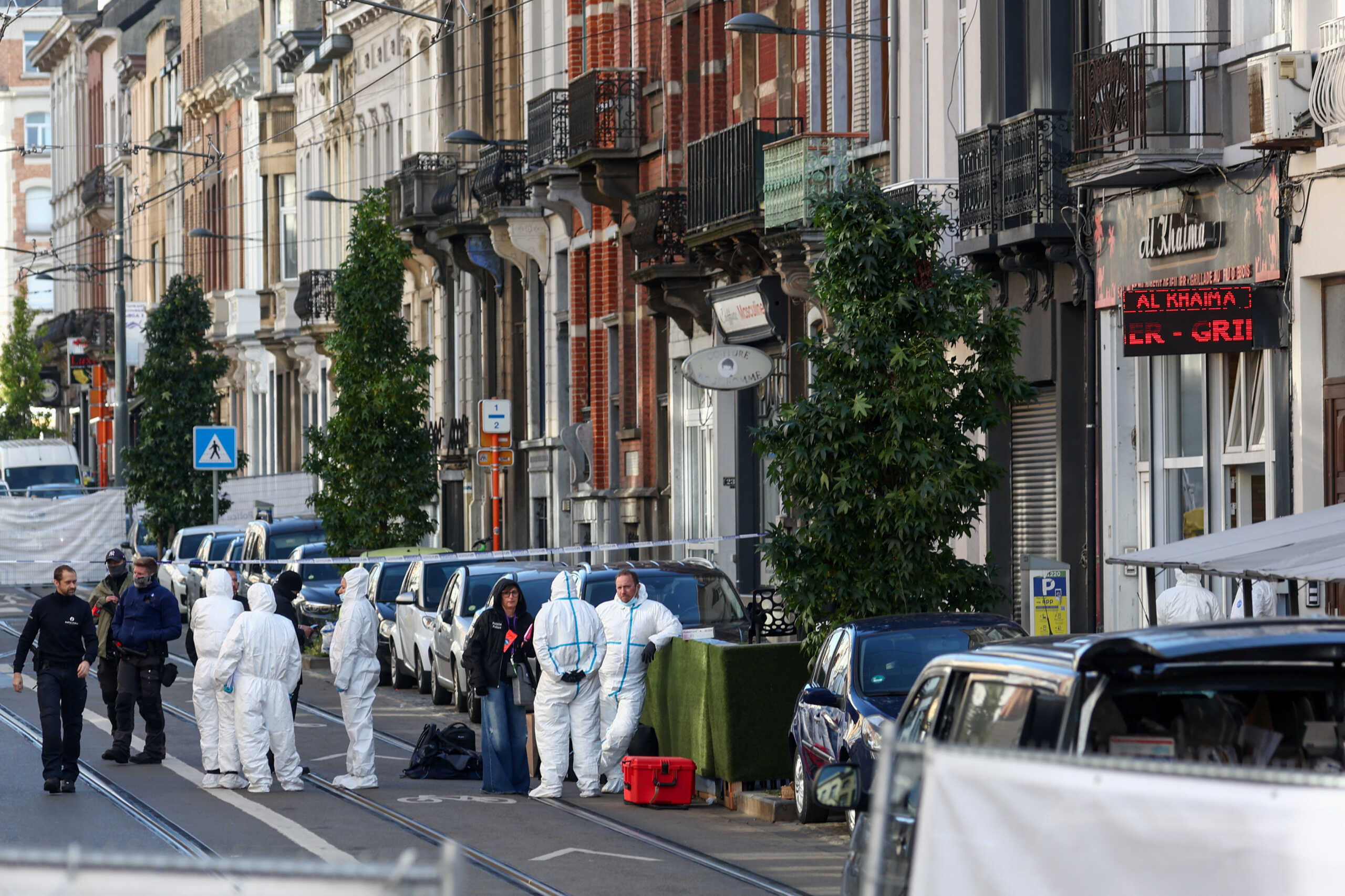 Police officers work outside the site of a police operation against a deadly shooting suspect, in Schaerbeek, Brussels, Belgium, October 17, 2023. REUTERS