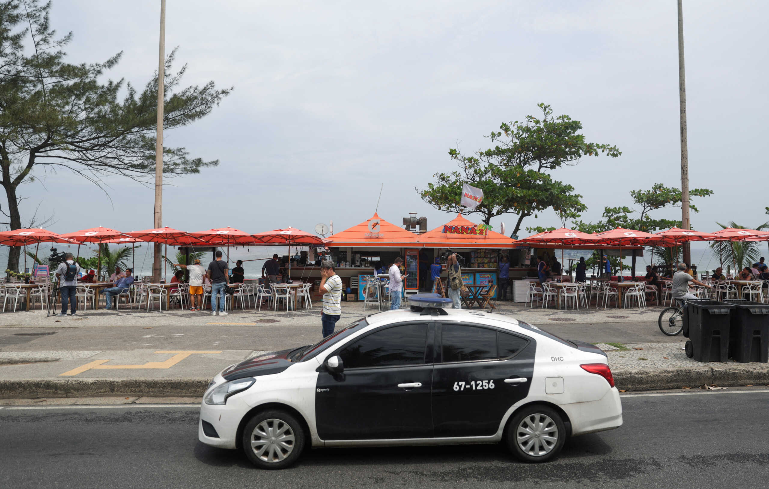 Police officers patrol next to a beachside food stand in Barra da Tijuca neighborhood where, according to a police's statement, physician Diego Ralf Bomfim, the brother of leftist lawmaker Samia Bomfim, was shot dead with his colleagues in a shooting, in Rio de Janeiro, Brazil, October 5, 2023. REUTERS
