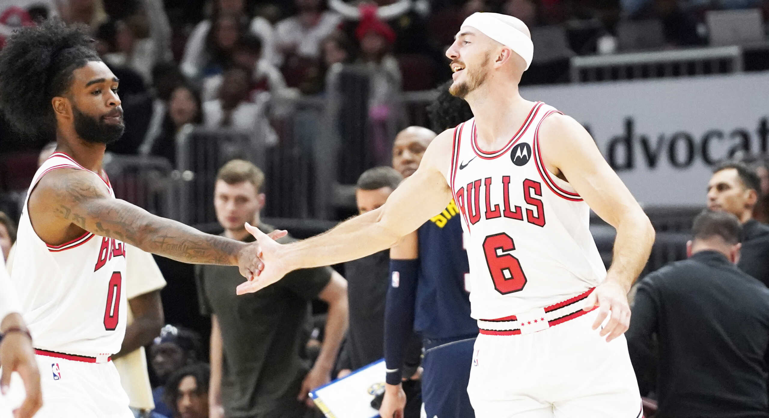 Oct 12, 2023; Chicago, Illinois, USA; Chicago Bulls guard Alex Caruso (6) celebrates his three point basket with guard Coby White (0) against the Denver Nuggets during the second half at United Center. Mandatory Credit: David Banks-USA TODAY Sports