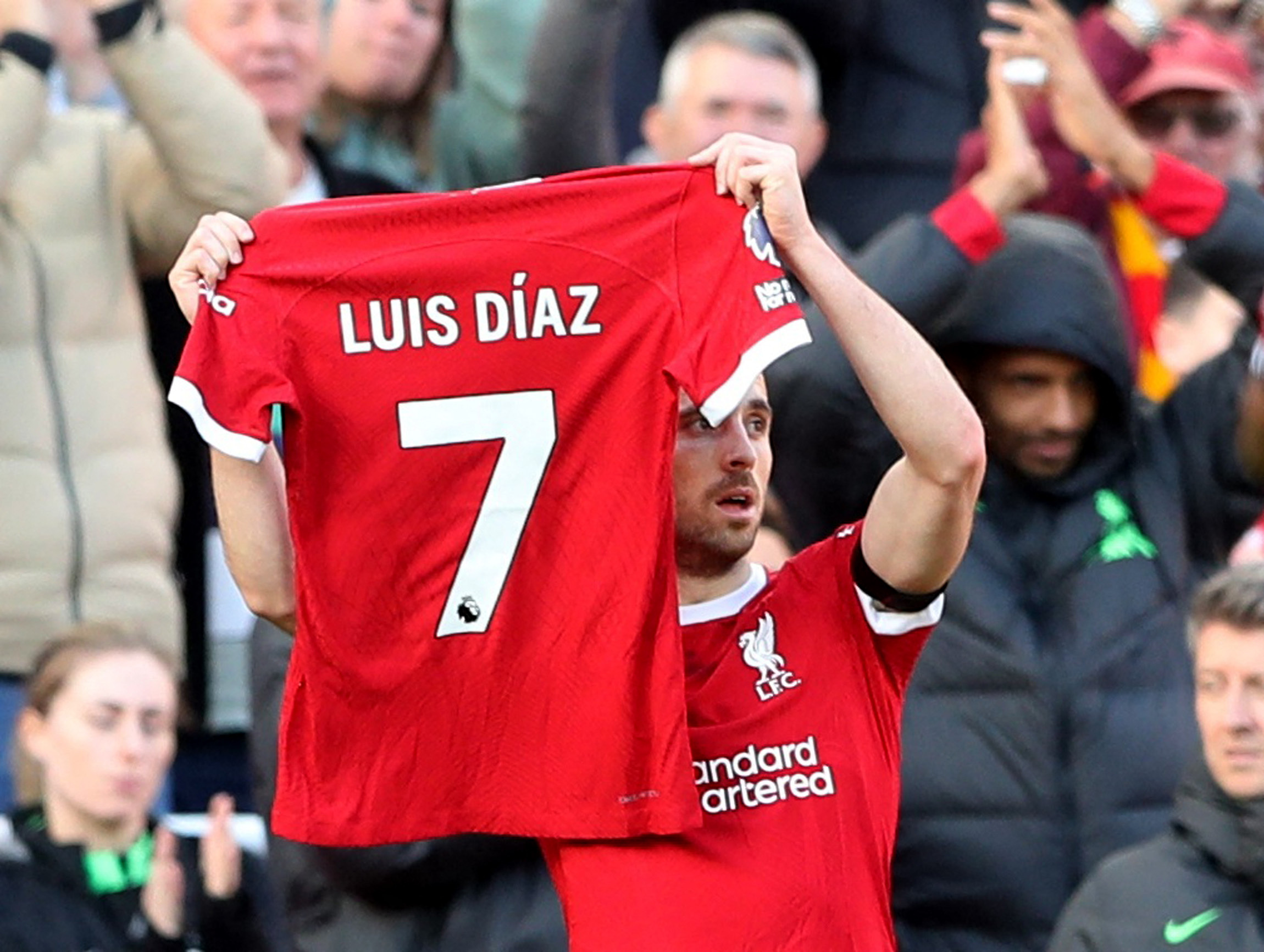 Soccer Football - Premier League - Liverpool v Nottingham Forest - Anfield, Liverpool, Britain - October 29, 2023  Liverpool's Diogo Jota holds up a shirt in support of Liverpool's Luis Diaz as he celebrates scoring their first goal REUTERS
