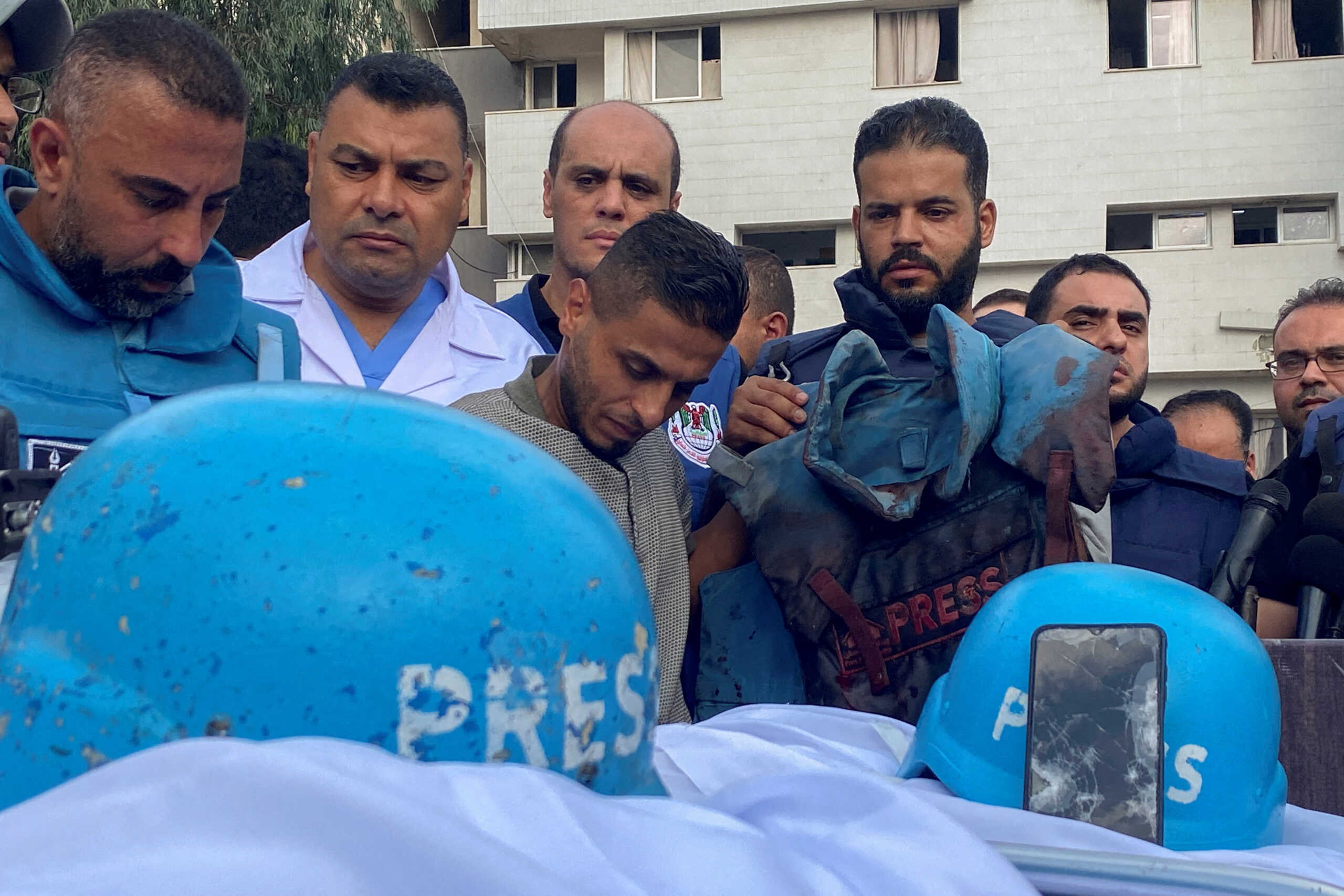 SENSITIVE MATERIAL. THIS IMAGE MAY OFFEND OR DISTURB  Colleagues of Palestinian journalists Mohammed Soboh and Saeed al-Taweel, who were killed when an Israeli missile hit a building while they were outside reporting, stand next to their bodies at a hospital in Gaza City, October 10, 2023.  REUTERS
