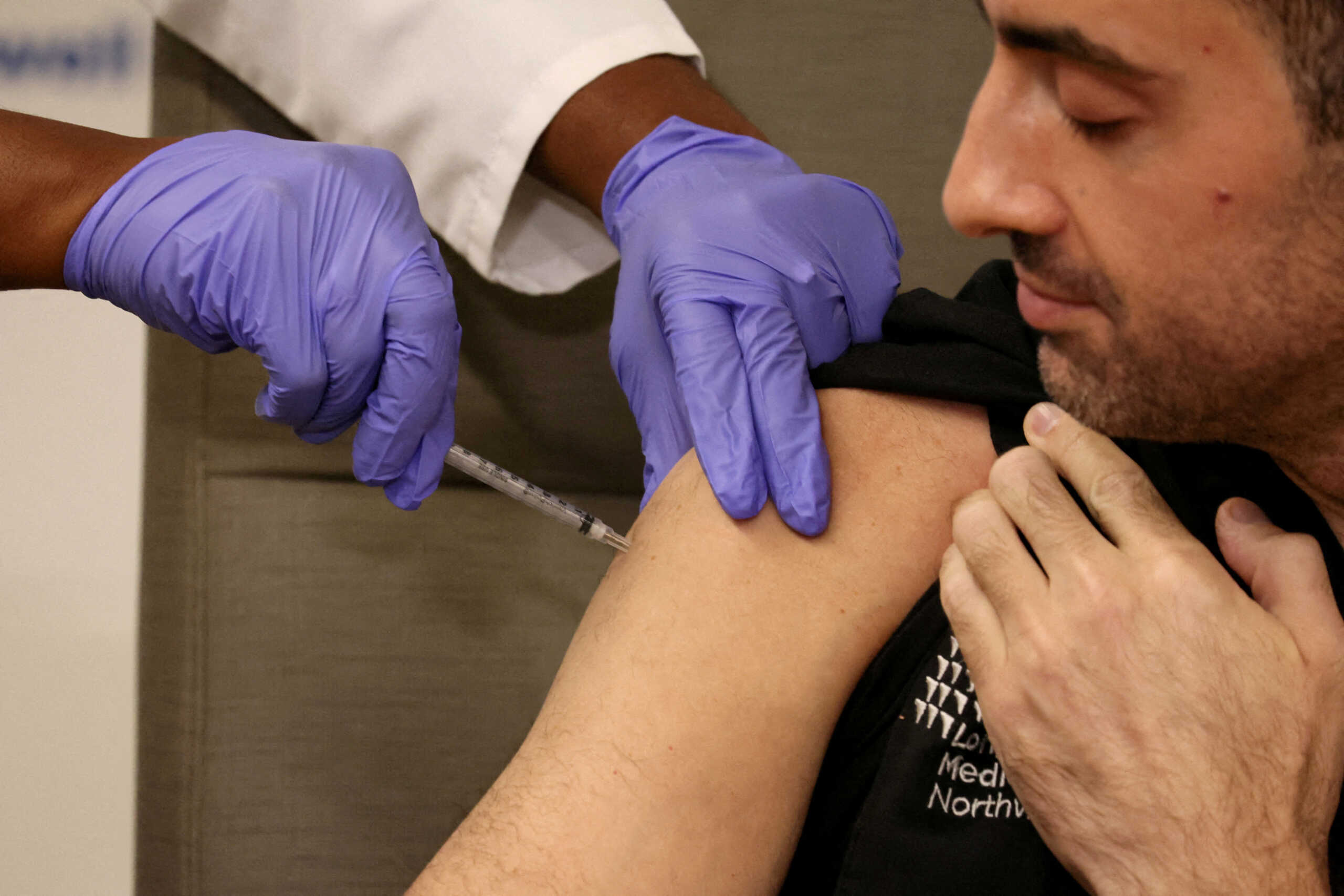 FILE PHOTO: Adam Berman, MD Associate Chair emergency medicine Long Island Jewish Medical Center, who was one of the first Americans to receive the initial COVID vaccine, is inoculated with the updated coronavirus disease (COVID-19) vaccine by Dr. Michelle Chester from Northwell Health at Long Island Jewish Medical Center in New Hyde Park, New York, U.S., September 13, 2023.  REUTERS