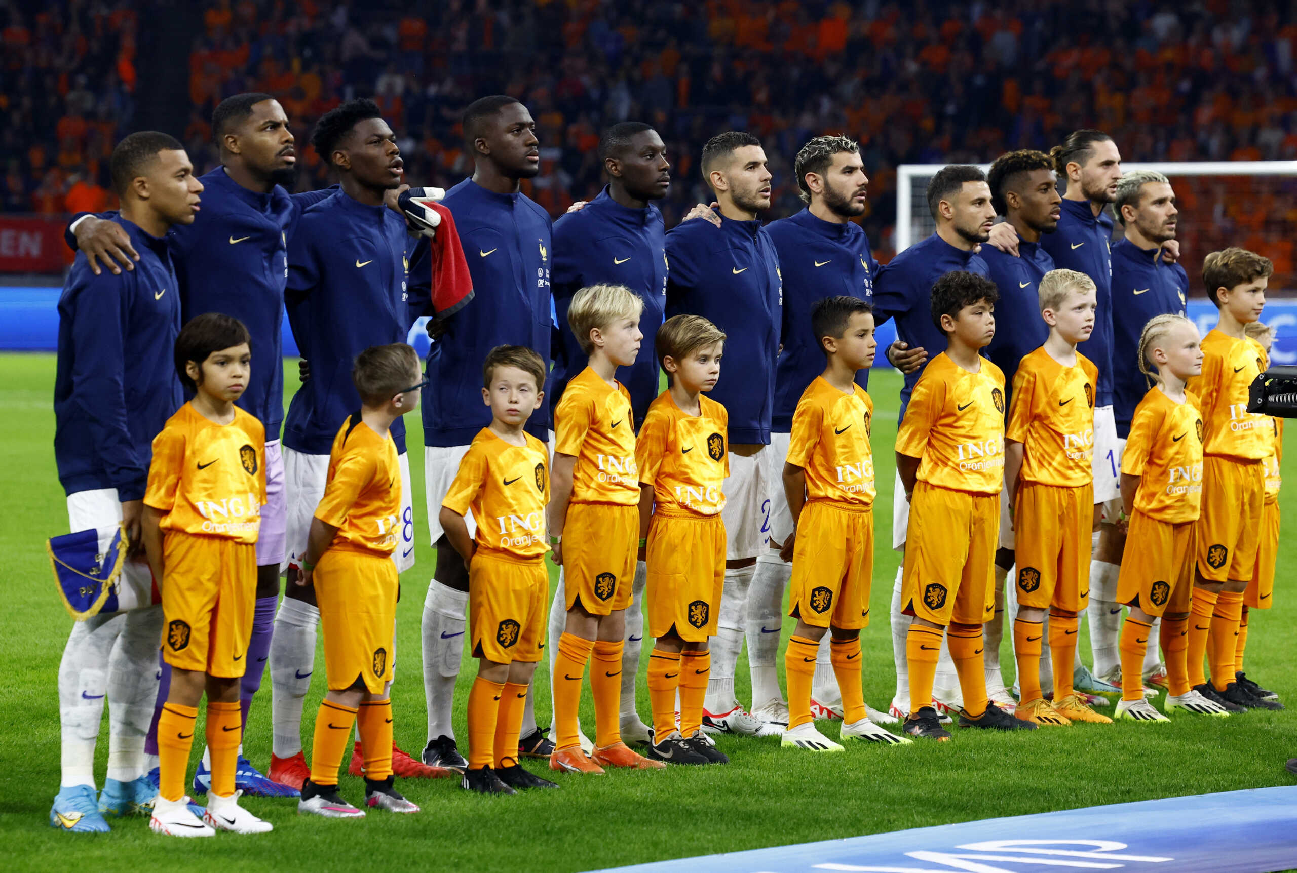 Soccer Football - Euro 2024 Qualifier - Group B - Netherlands v France - Johan Cruyff Arena, Amsterdam, Netherlands - October 13, 2023 France players line up with young mascots during the warm up before the match REUTERS