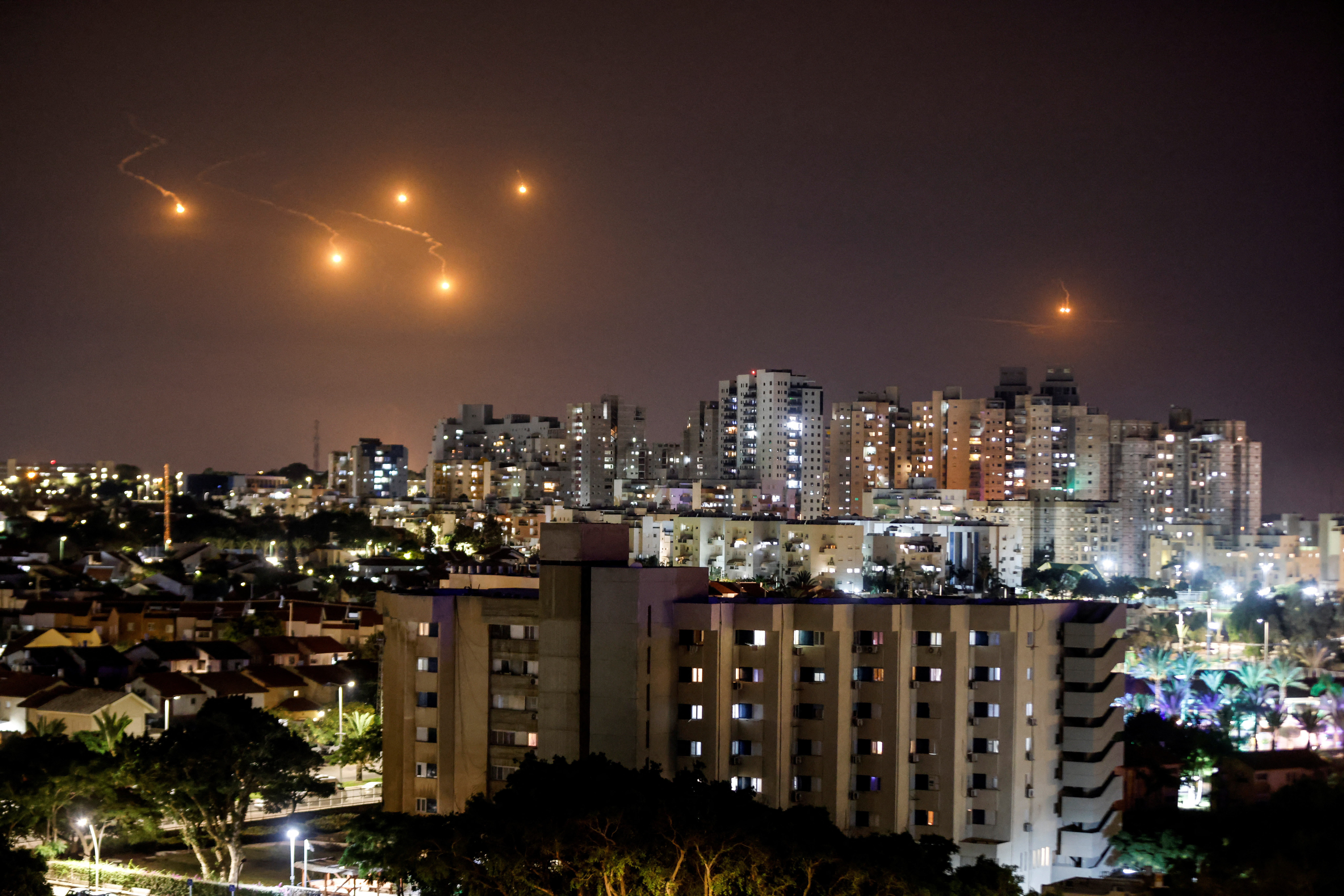 Flares illuminate the sky over northern Gaza, as seen from Ashkelon, southern Israel October 7, 2023. REUTERS