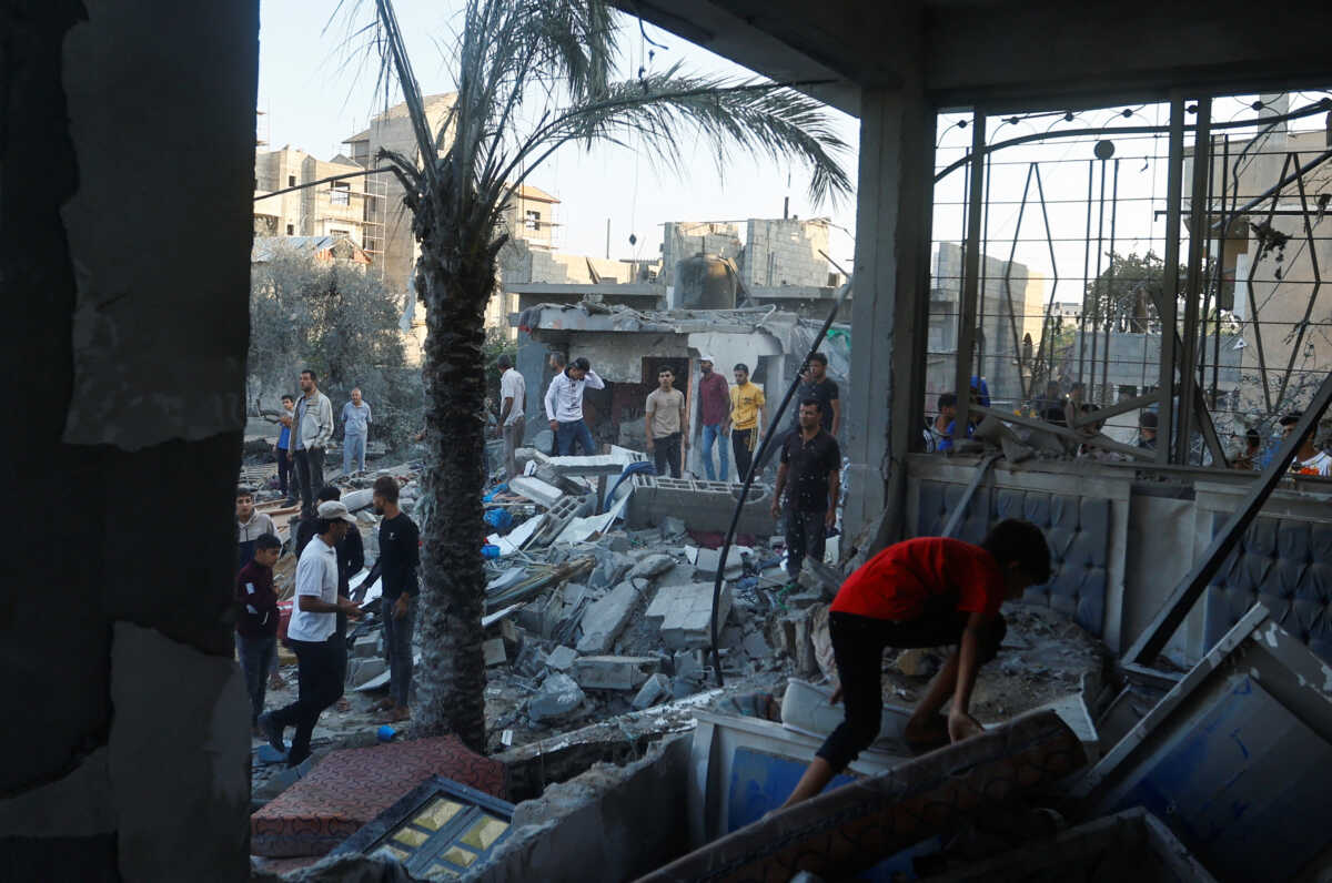 A Palestinian walks through the rubble of a house destroyed in Israeli strikes amid the conflict with Israel in Khan Younis, in the southern Gaza Strip, October 12, 2023. REUTERS