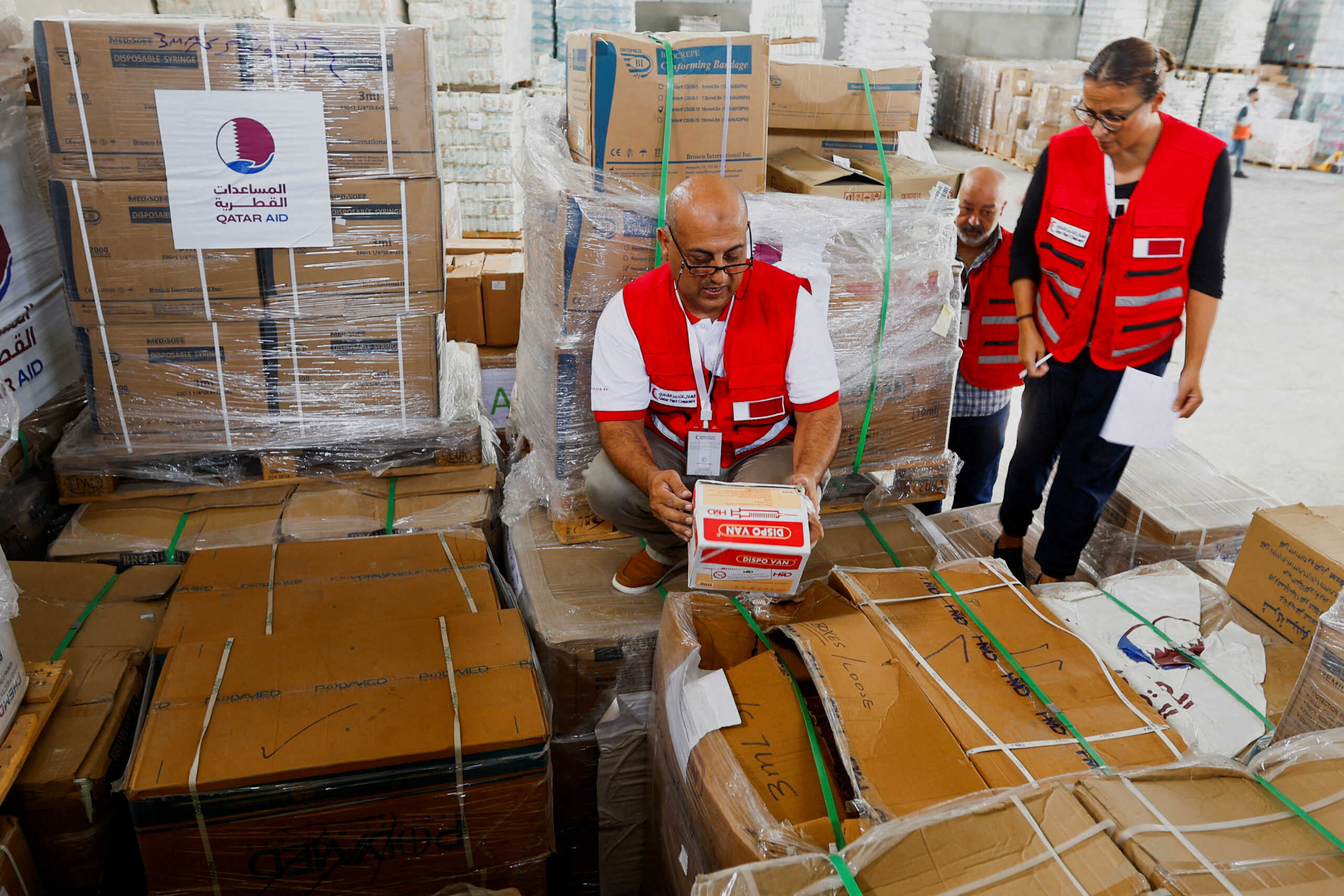 Red Crescent workers sort aid before being distributed to Palestinians, as the conflict between Israel and Palestinian Islamist group Hamas continues, in Khan Younis in the southern Gaza Strip, October 23, 2023. REUTERS