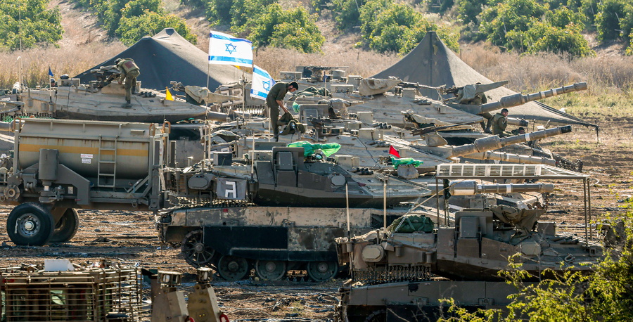 epa10930312 Israeli soldiers and armored vehicles are gathered at an undisclosed location near the border with Gaza, in Israel, 21 October 2023. More than 4,000 Palestinians and 1,400 Israelis have been killed according to the Israel Defense Forces (IDF) and the Palestinian health authority since Hamas militants launched an attack against Israel from the Gaza Strip on 07 October. In the latest developments, Egypt is due to host, on 21 October, an international summit on the situation in Gaza, and after a Qatari mediation, two hostages have been released by Hamas on the evening of 20 October as confirmed by their relatives, Israeli officials and Hamas.  EPA