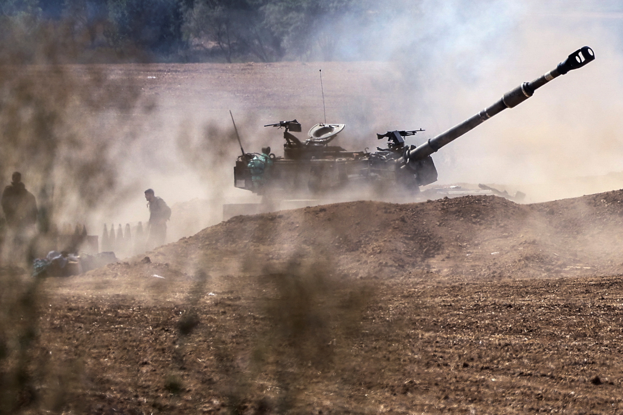 A tank and soldiers from an artillery unit gather near Israel's border with the Gaza Strip, in southern Israel, October 12, 2023. REUTERS