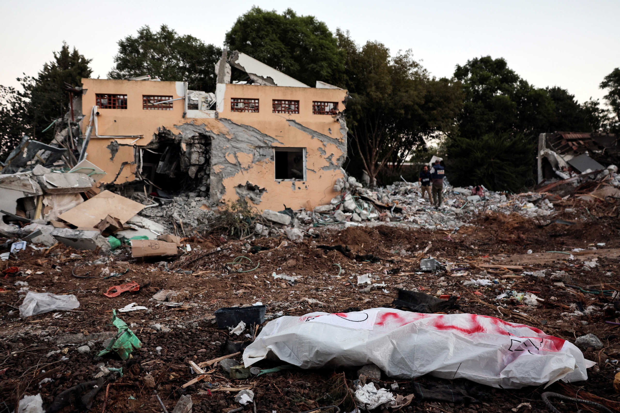 A dead body lies on the ground following a mass infiltration by Hamas gunmen from the Gaza Strip, in Kibbutz Beeri in southern Israel, October 11, 2023. REUTERS