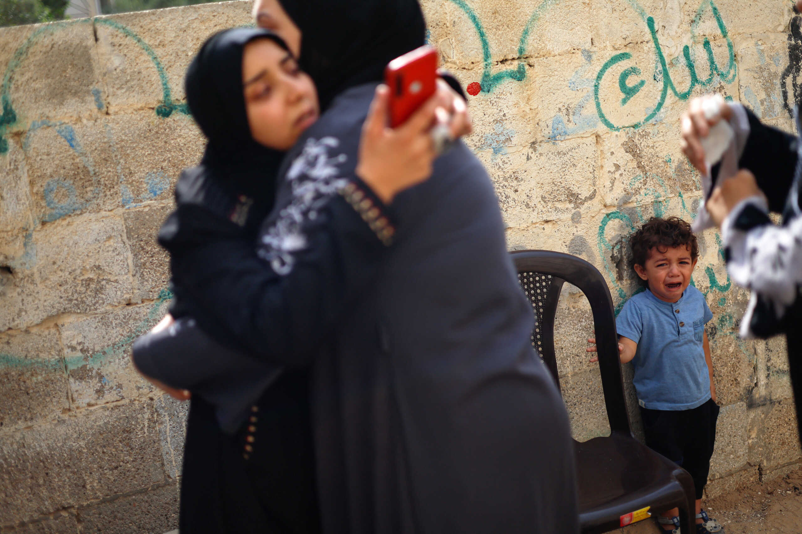 A young child reacts as mourners attend the funeral of Palestinians from the Shamalkh family, who health officials said were killed in Israeli strikes, in Gaza City, October 9, 2023. REUTERS