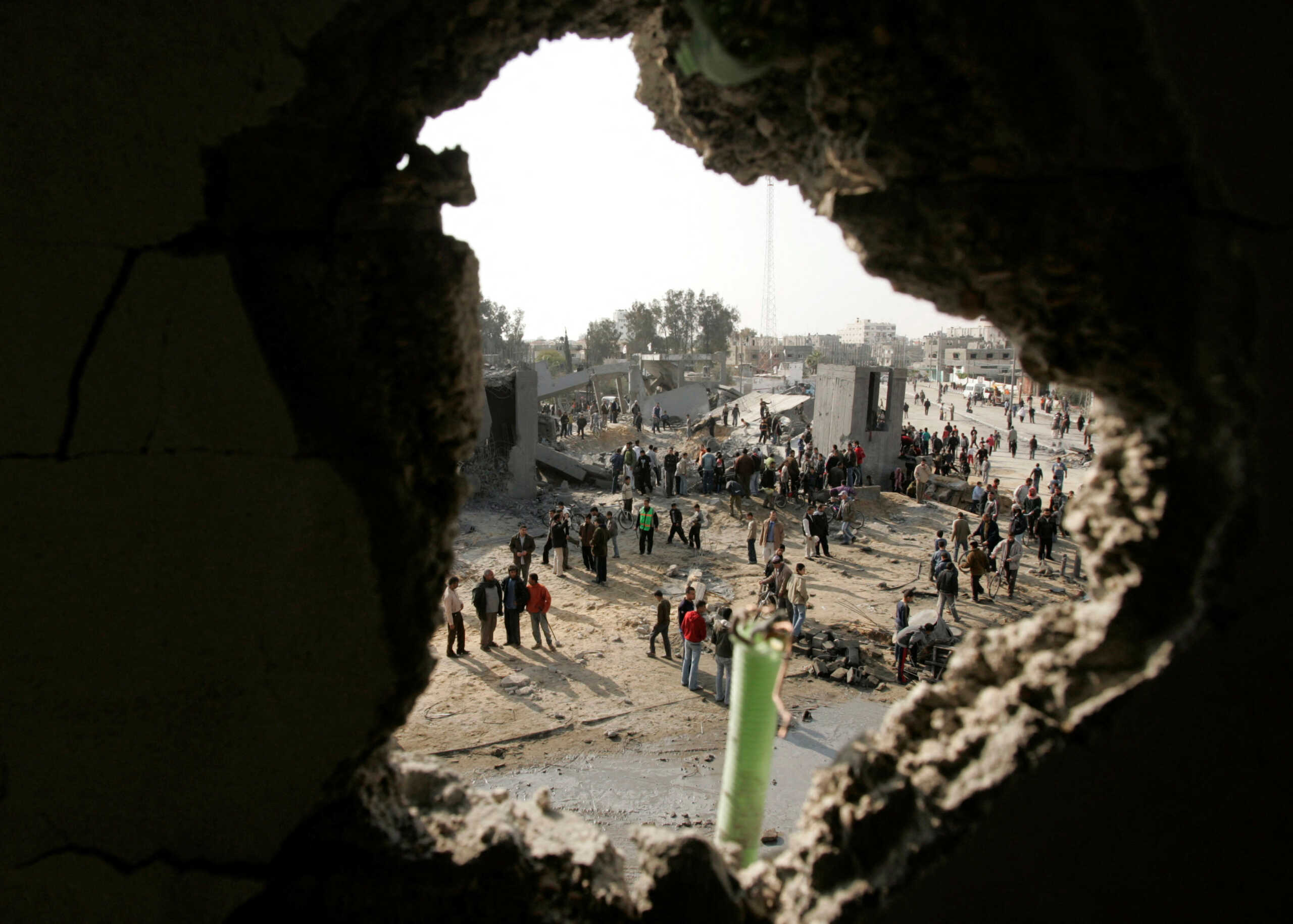 FILE PHOTO: Palestinians inspect Badr mosque after witnesses said it was bombed by Israeli military aircraft on Saturday, in the southern Gaza Strip March 2, 2008. REUTERS