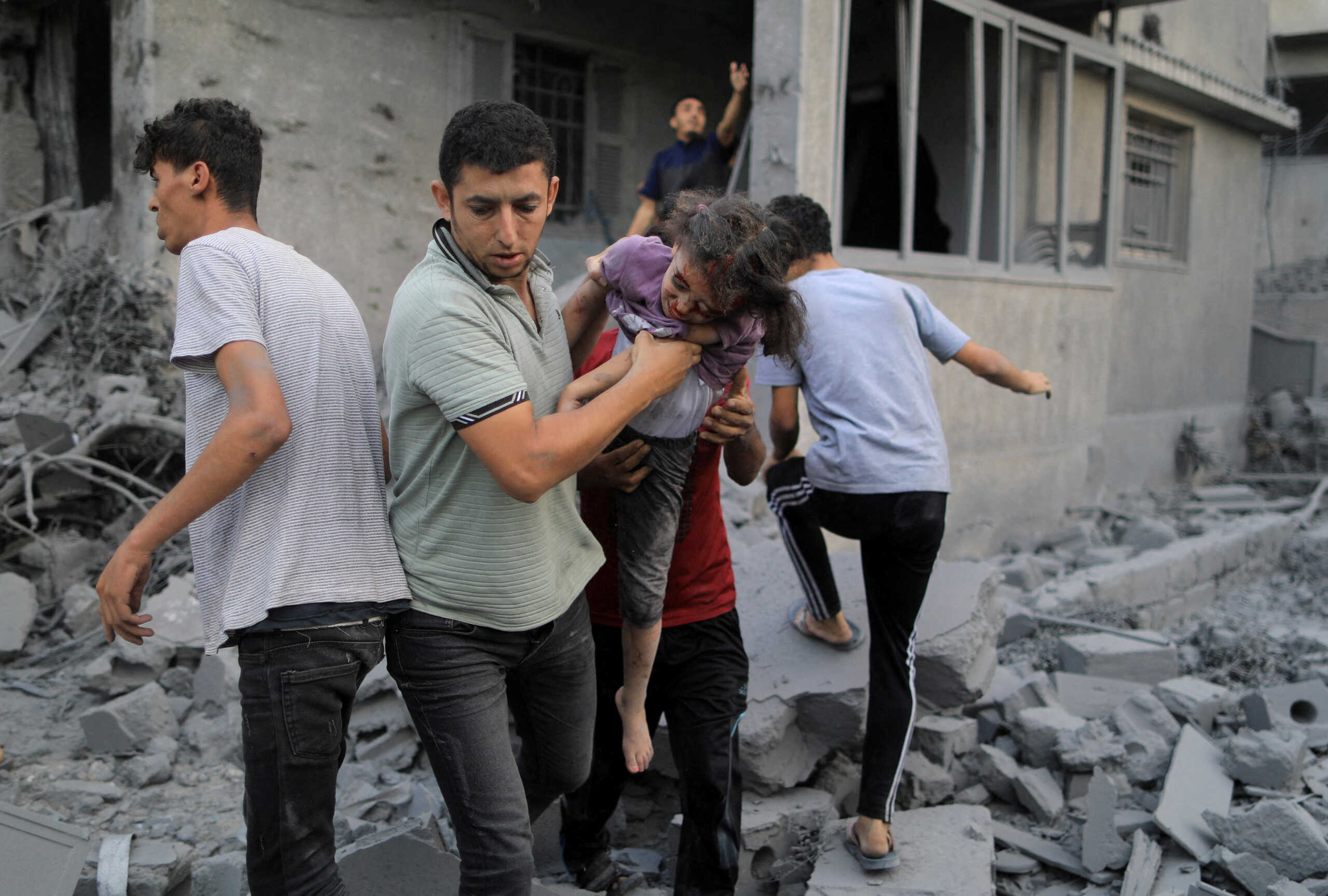SENSITIVE MATERIAL. THIS IMAGE MAY OFFEND OR DISTURB    Palestinians carry a wounded girl rescued from the rubble of a house after it was hit by Israeli strikes, in Khan Younis in the southern Gaza Strip October 14, 2023. REUTERS