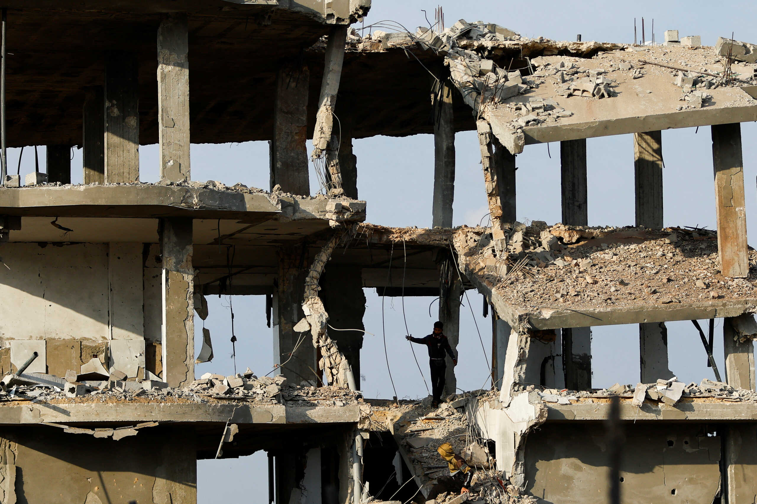 A Palestinian boy walks through the rubble of a damaged house hit by Israeli strikes, in Khan Younis in the southern Gaza Strip October 11, 2023. REUTERS