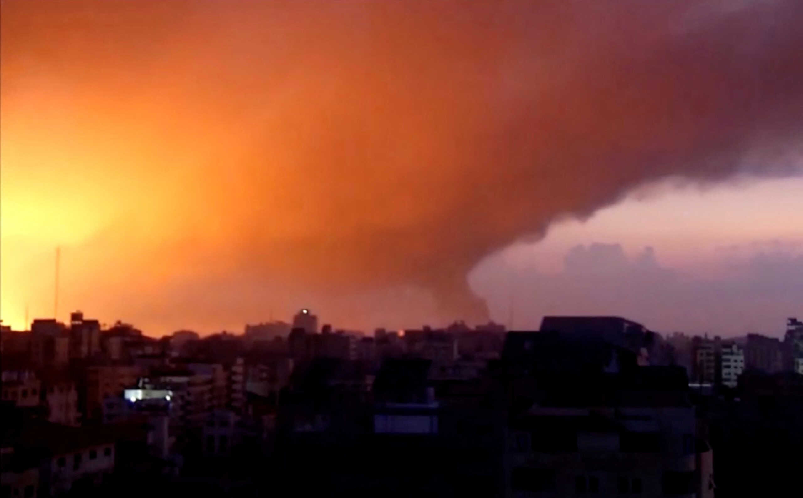 Smoke and flames rise as Israeli air strikes bombard Gaza as seen from Gaza City in this still picture taken from a video, October 14, 2023. REUTERS
