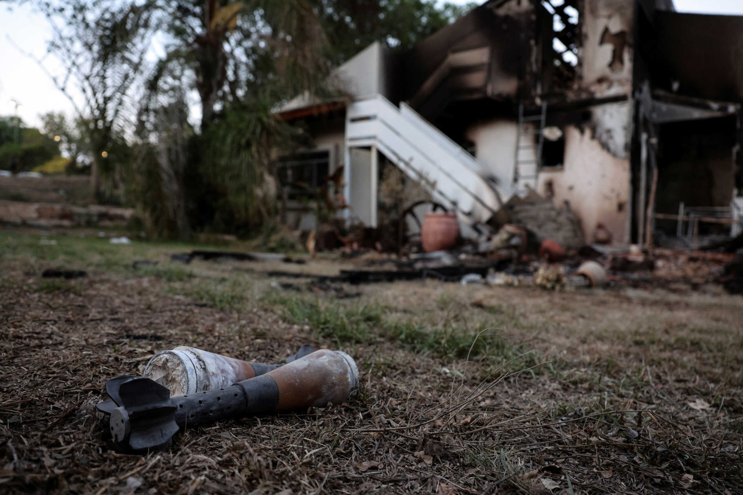 A mortar shell lies on grass following a mass infiltration by Hamas gunmen from the Gaza Strip, in Kibbutz Beeri in southern Israel, October 11, 2023. REUTERS