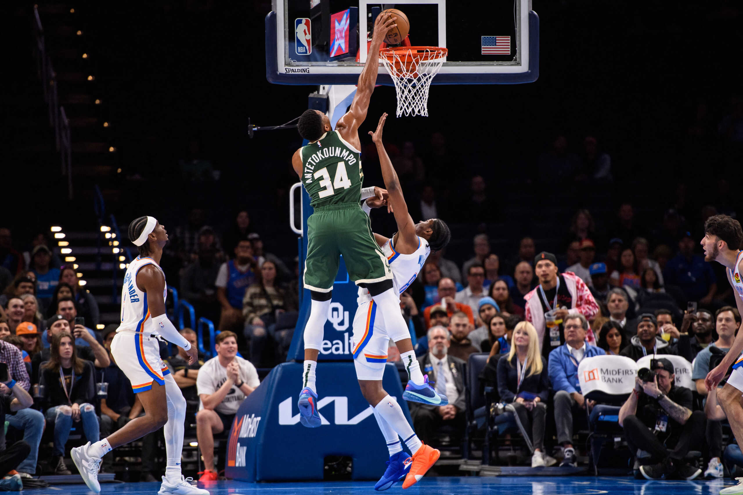 Oct 17, 2023; Oklahoma City, Oklahoma, USA; Milwaukee Bucks forward Giannis Antetokounmpo (34) dunks over Oklahoma City Thunder forward Jalen Williams (8) during the first half at Paycom Center. Mandatory Credit: Rob Ferguson-USA TODAY Sports