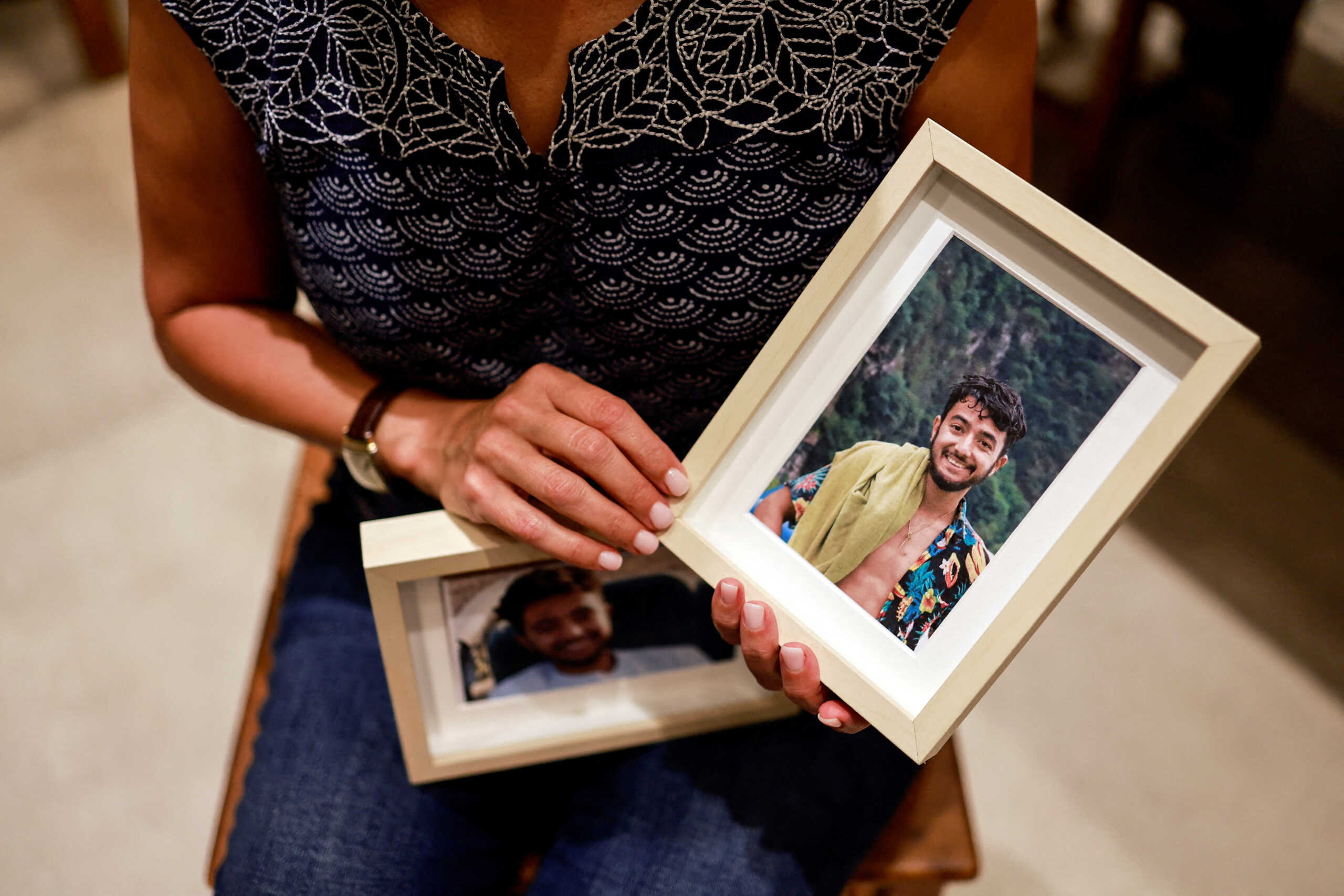 FILE PHOTO: Rachel Goldberg, U.S.-Israeli mother of Hersh Goldberg Polin, which was taken hostage by Hamas militants into the Gaza Strip while attending a music festival in south Israel, holds photos of her son in their home, in Jerusalem October 17, 2023 REUTERS