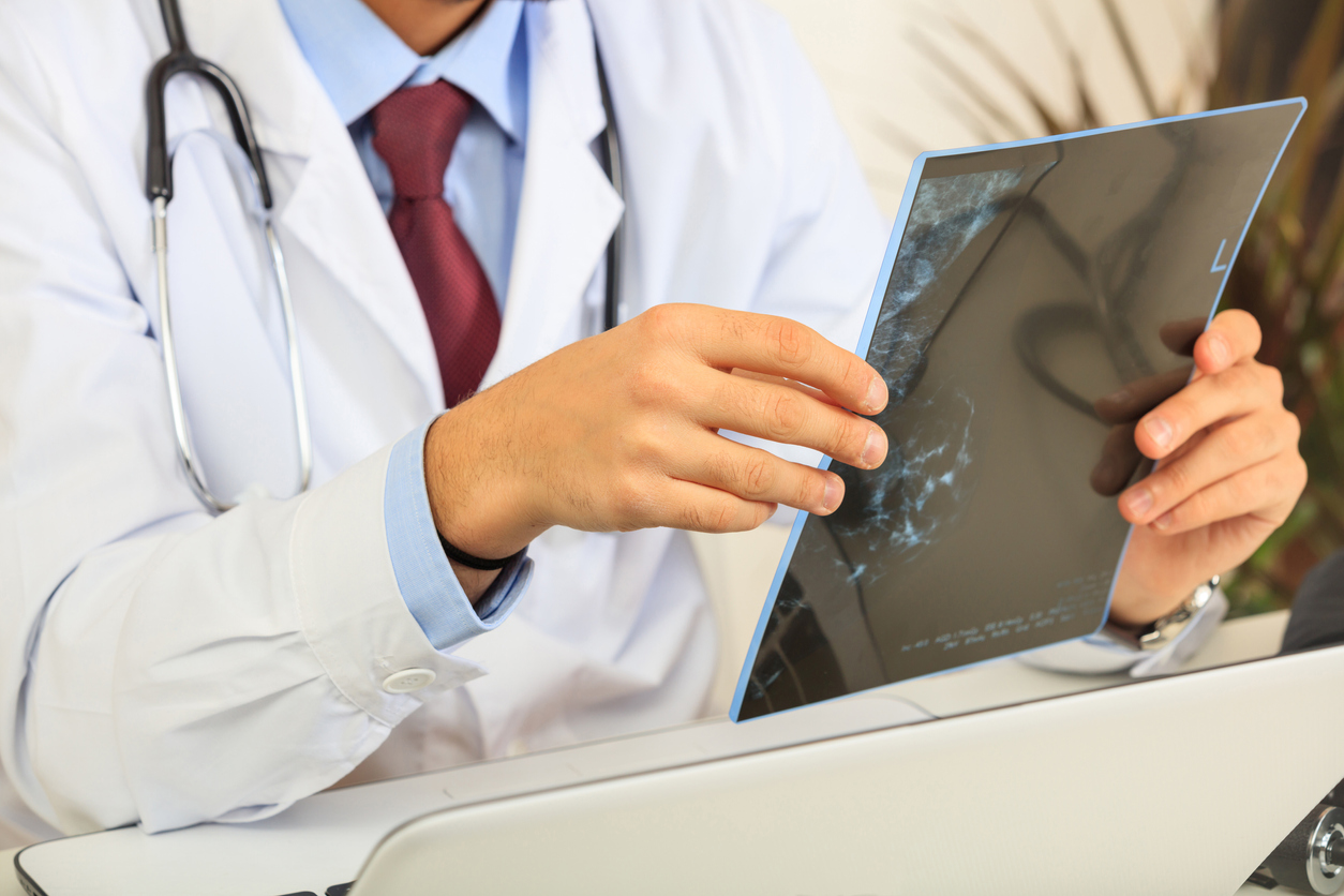 Doctor on his desk looking at a mammography