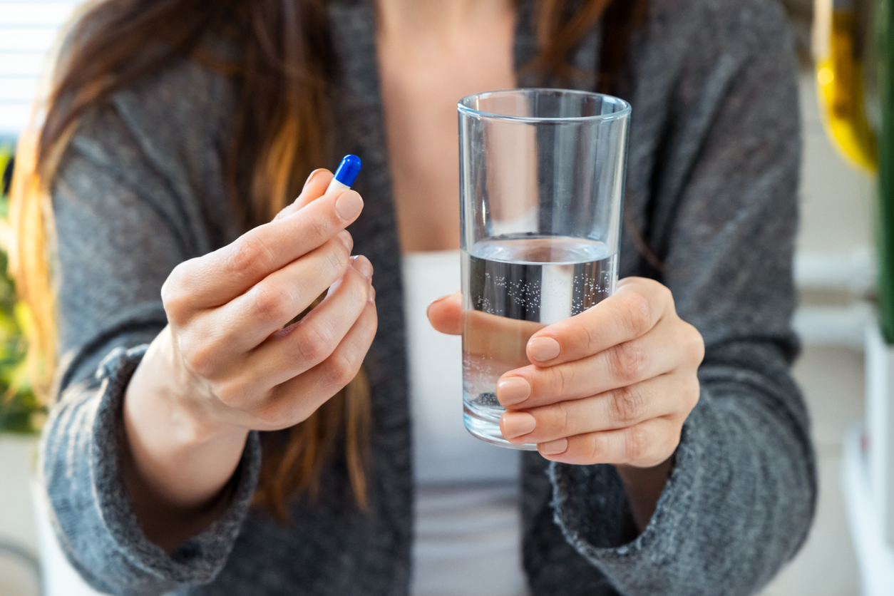 Close-up of woman hands holding medicine pills