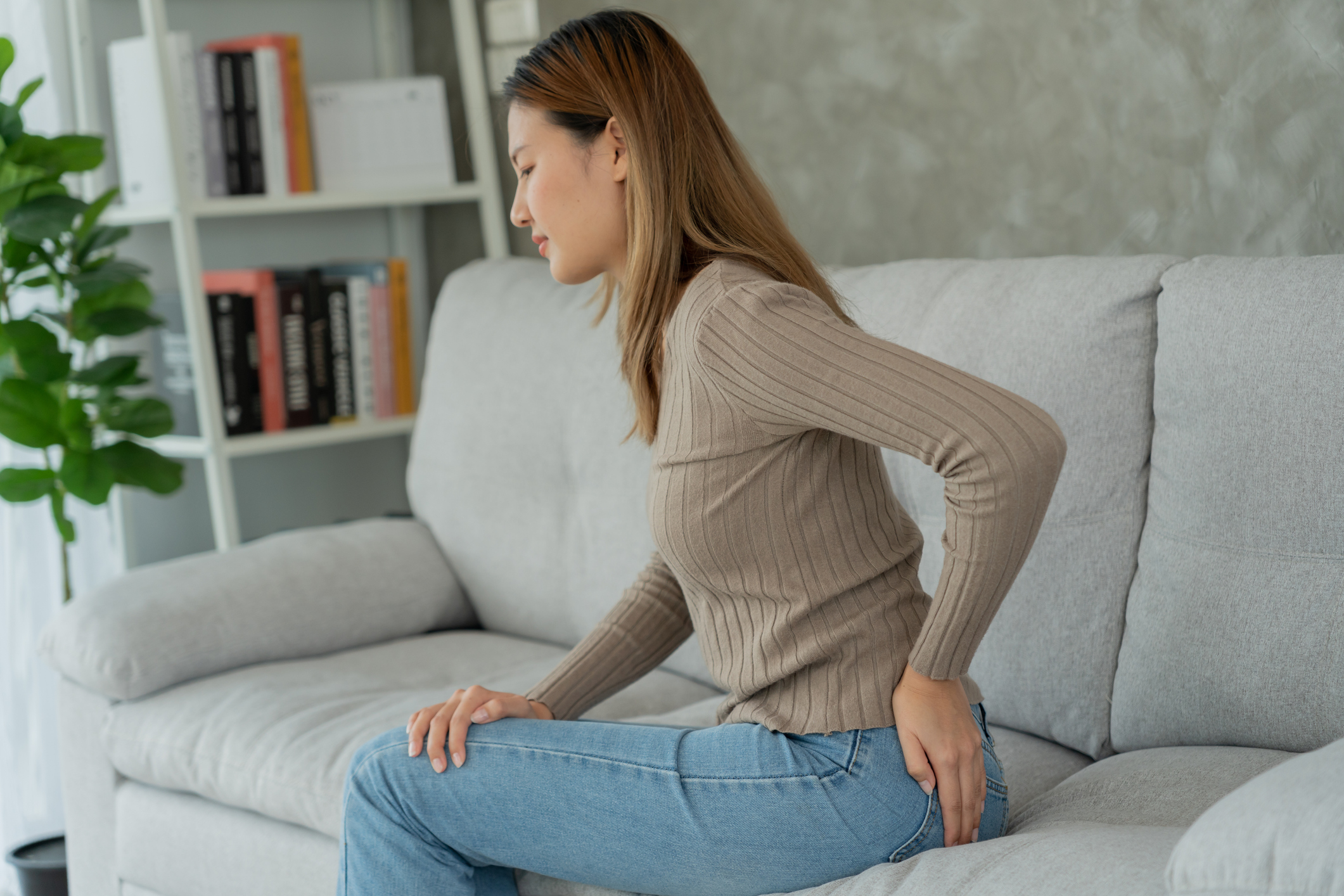 Asian Female hand holding her bottom because having abdominal pain and hemorrhoids, health care, constipation, Anatomical, suffering from pain, abdominal, bowel problem, bloody diarrhea, stomach ache