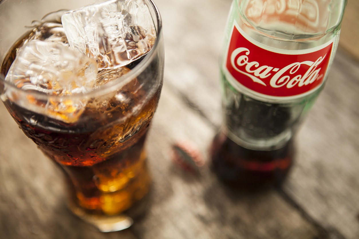 Lake Hopatcong, USA - December  13, 2012 Coca-Cola bottle and glass on picnic table