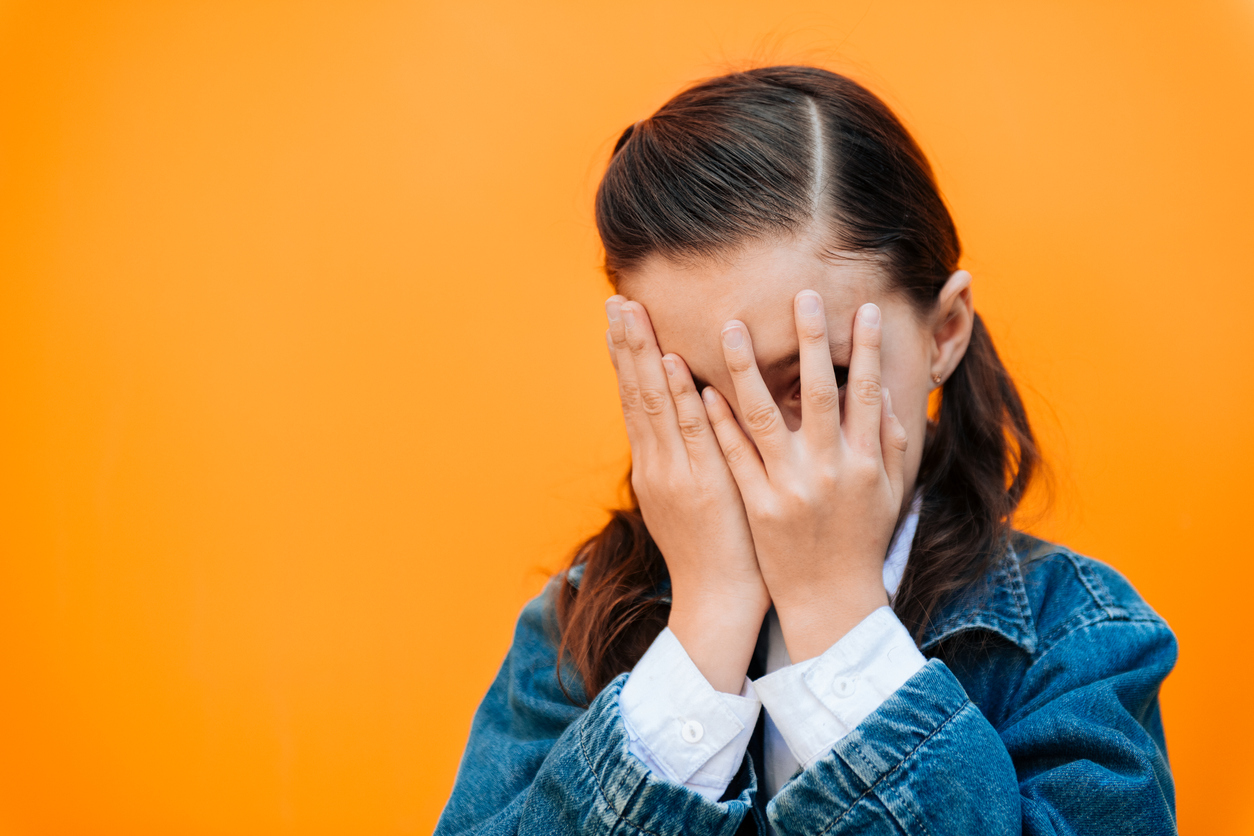 Little Girl covering face with hands