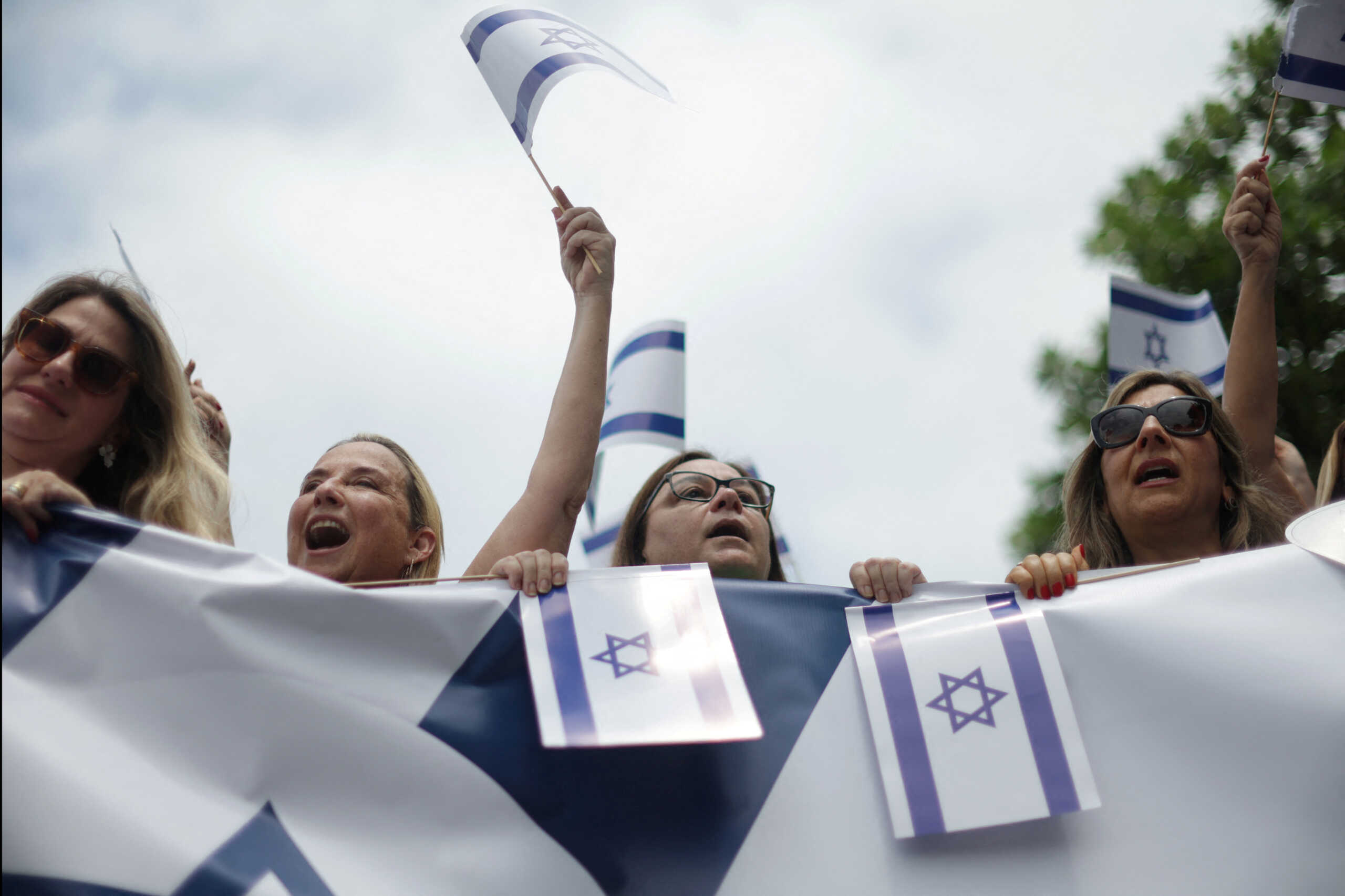 People hold Israel's national flags during a demonstration in support of Israel, in Copacabana beach in Rio de Janeiro, Brazil October 15, 2023. REUTERS