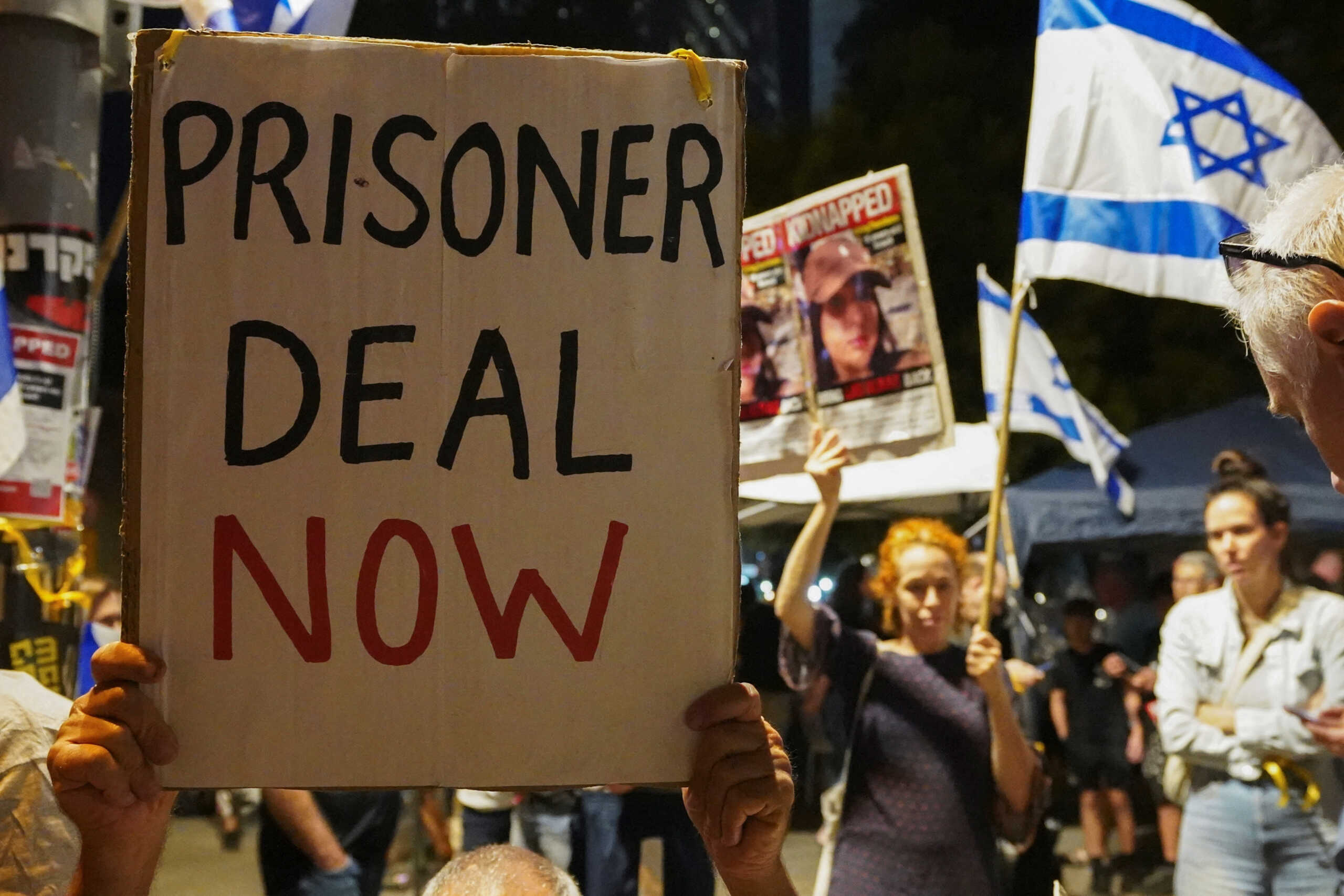 People hold placards during a demonstration to show support and solidarity with the families of hostages who are being held in Gaza, amid the ongoing conflict between Israel and Hamas, in Tel Aviv, Israel, October 21, 2023. REUTERS
