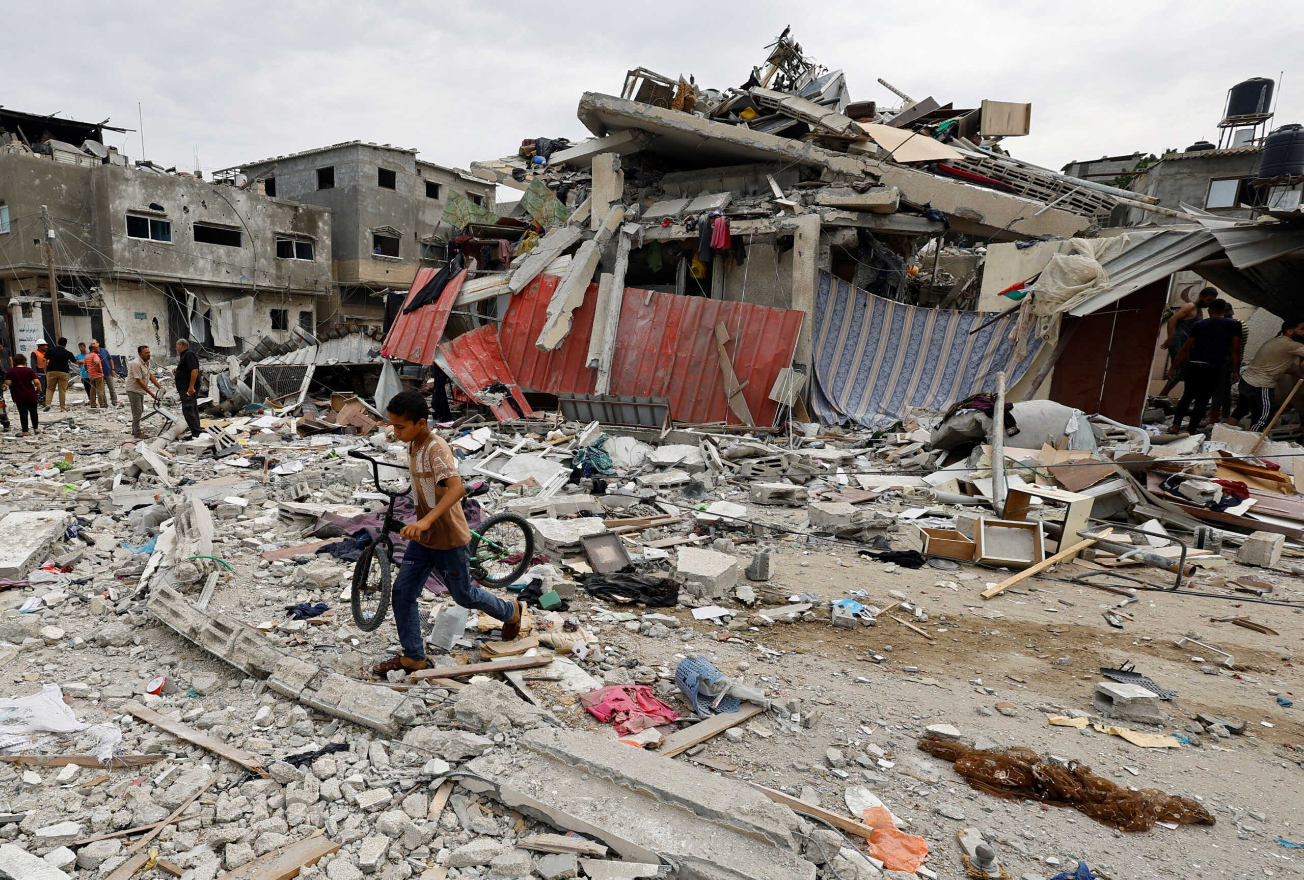 A child walks at the site of an Israeli air strike on a house, as the conflict between Israel and Palestinian Islamist group Hamas continues, in Khan Younis in the southern Gaza Strip, October 27, 2023. REUTERS