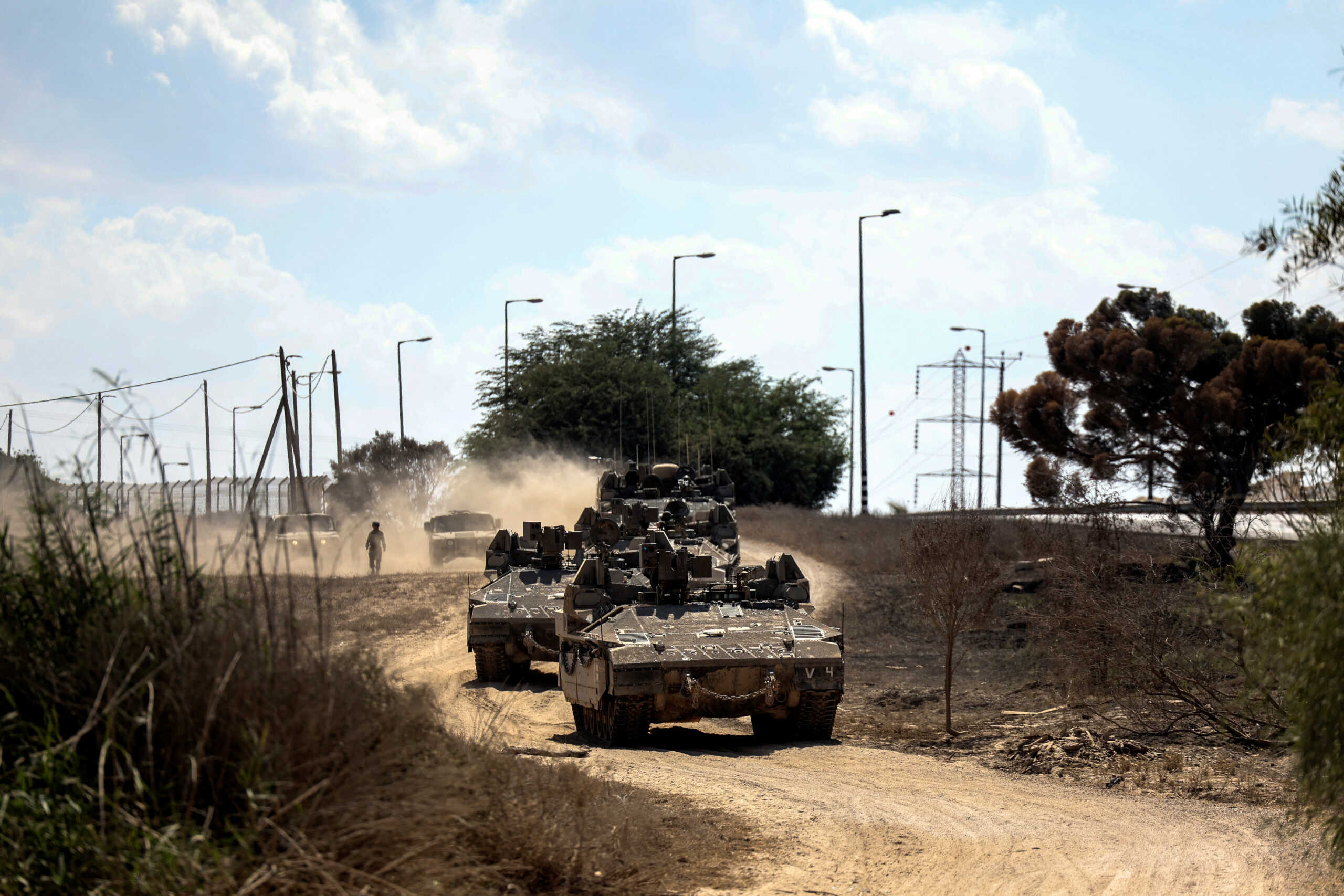 Israeli military vehicles drive near Israel's border with the Gaza Strip, in southern Israel, October 15, 2023. REUTERS