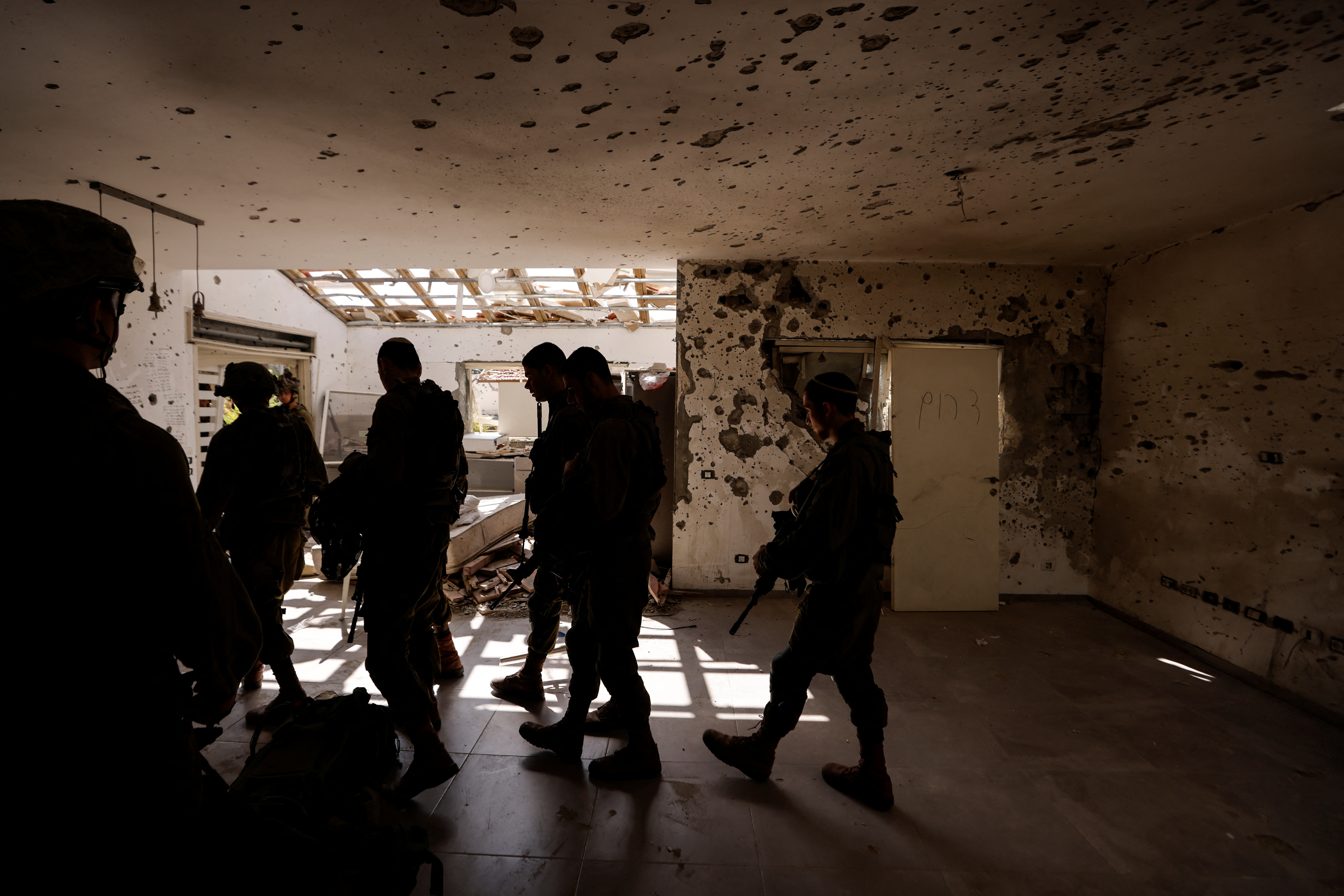 Israeli soldiers patrol the remains of Kibbutz Beeri, following a mass infiltration by Hamas gunmen from the Gaza Strip, in southern Israel, October 13, 2023. REUTERS