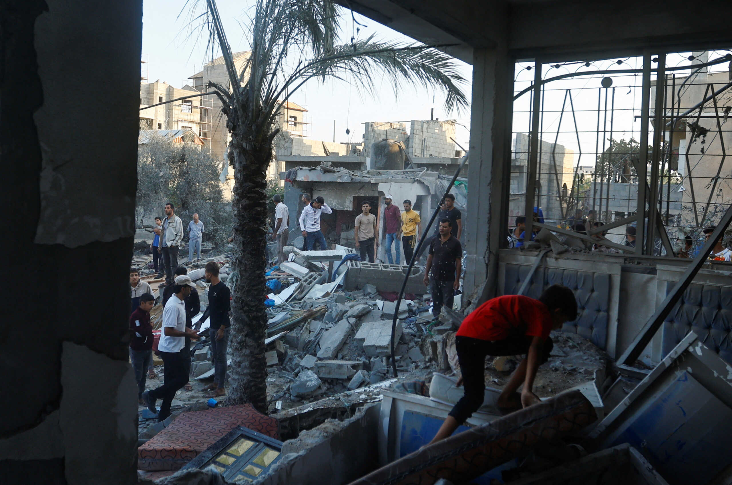 A Palestinian walks through the rubble of a house destroyed in Israeli strikes amid the conflict with Israel in Khan Younis, in the southern Gaza Strip, October 12, 2023. REUTERS