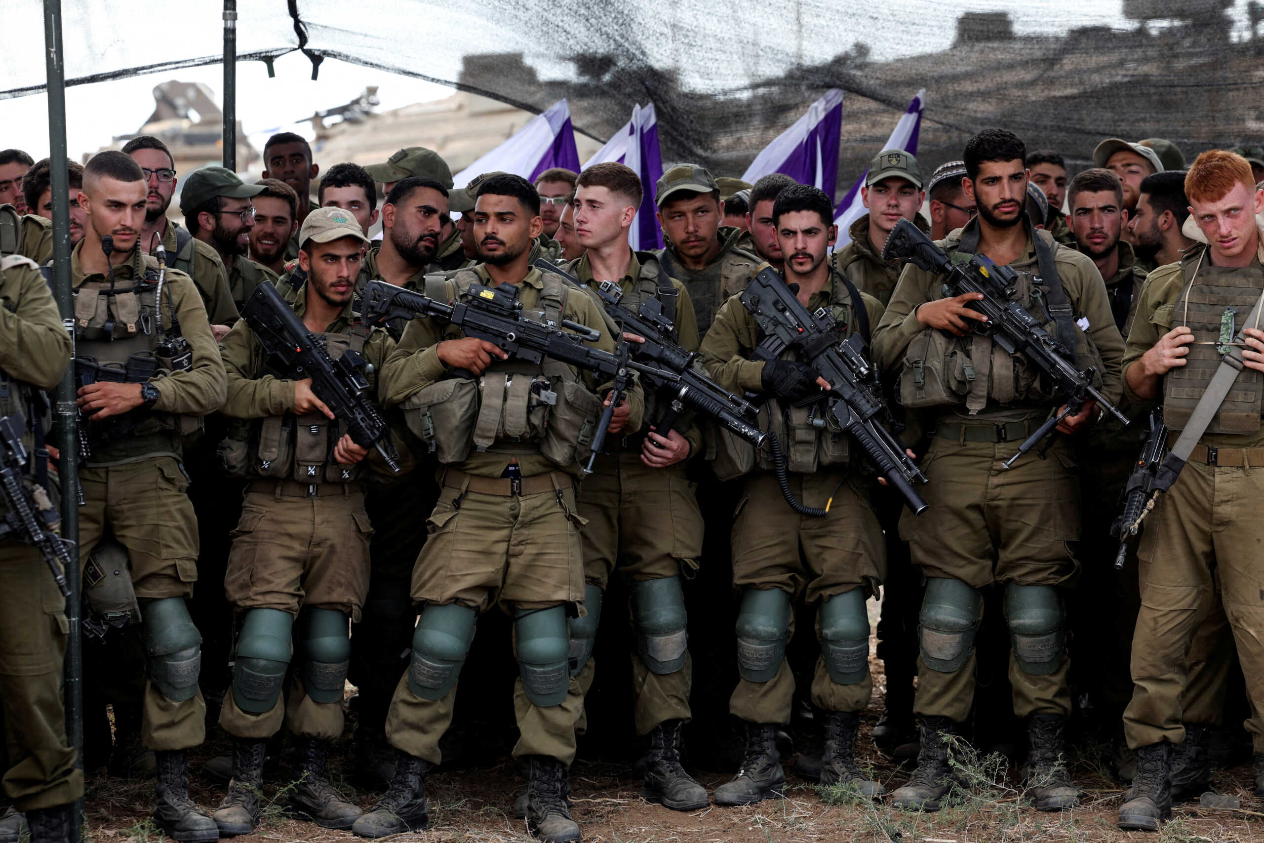 Israeli soldiers listen to Israel's Defence Minister Yoav Gallant as he meets them in a field near Israel's border with the Gaza Strip, in southern Israel October 19, 2023. REUTERS