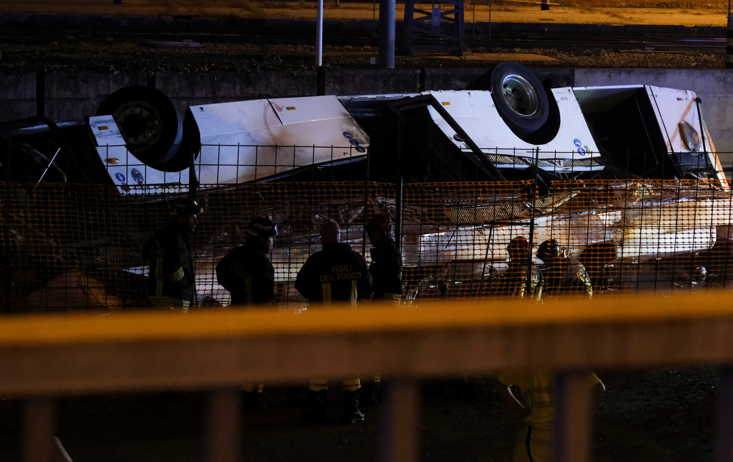 Rescue personnel attend the scene, after a coach crashed off an overpass in Mestre, Italy, October 3, 2023. REUTERS
